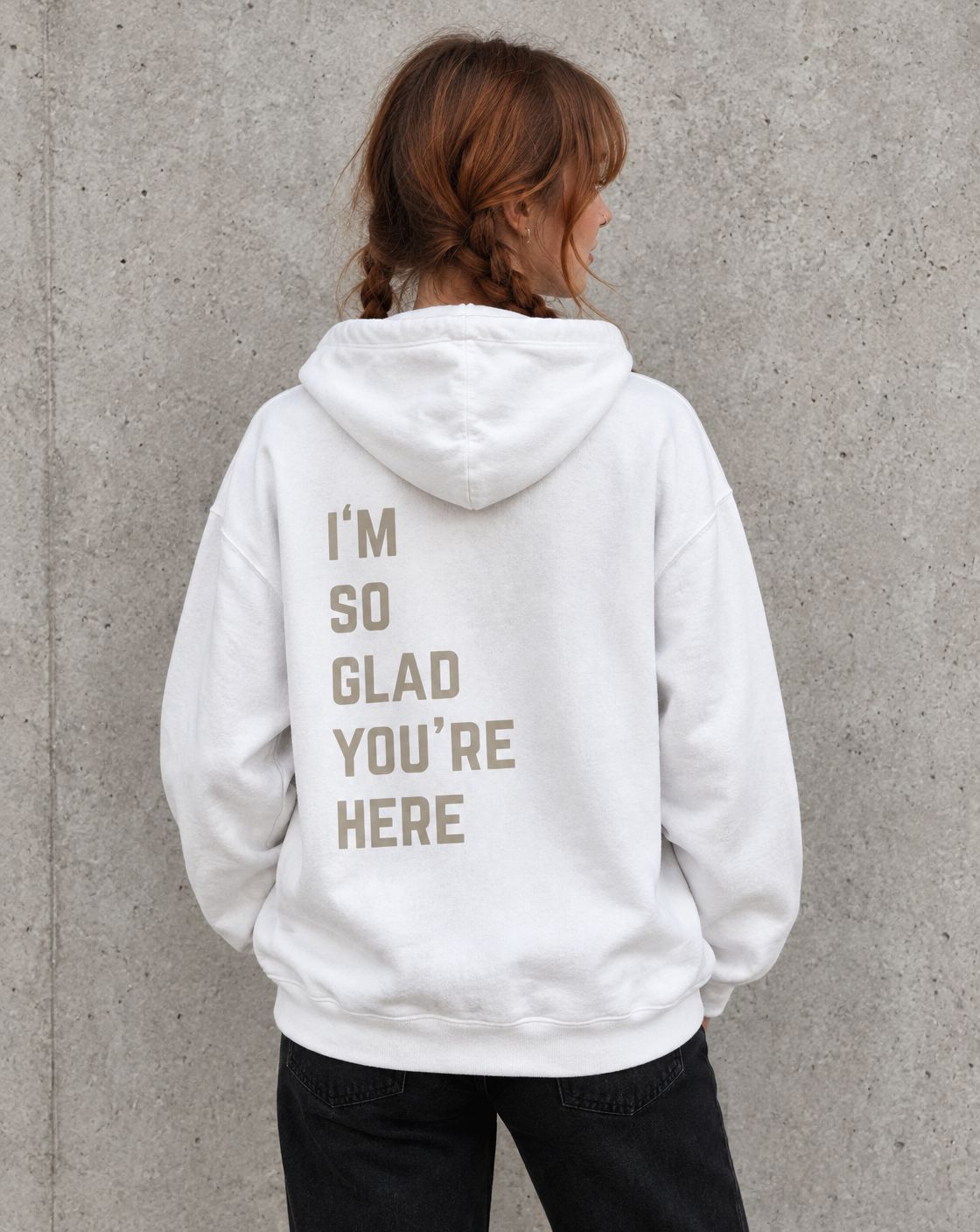 Model wearing the white I'm So Glad You're Here suicide awareness pullover hoodie, back view