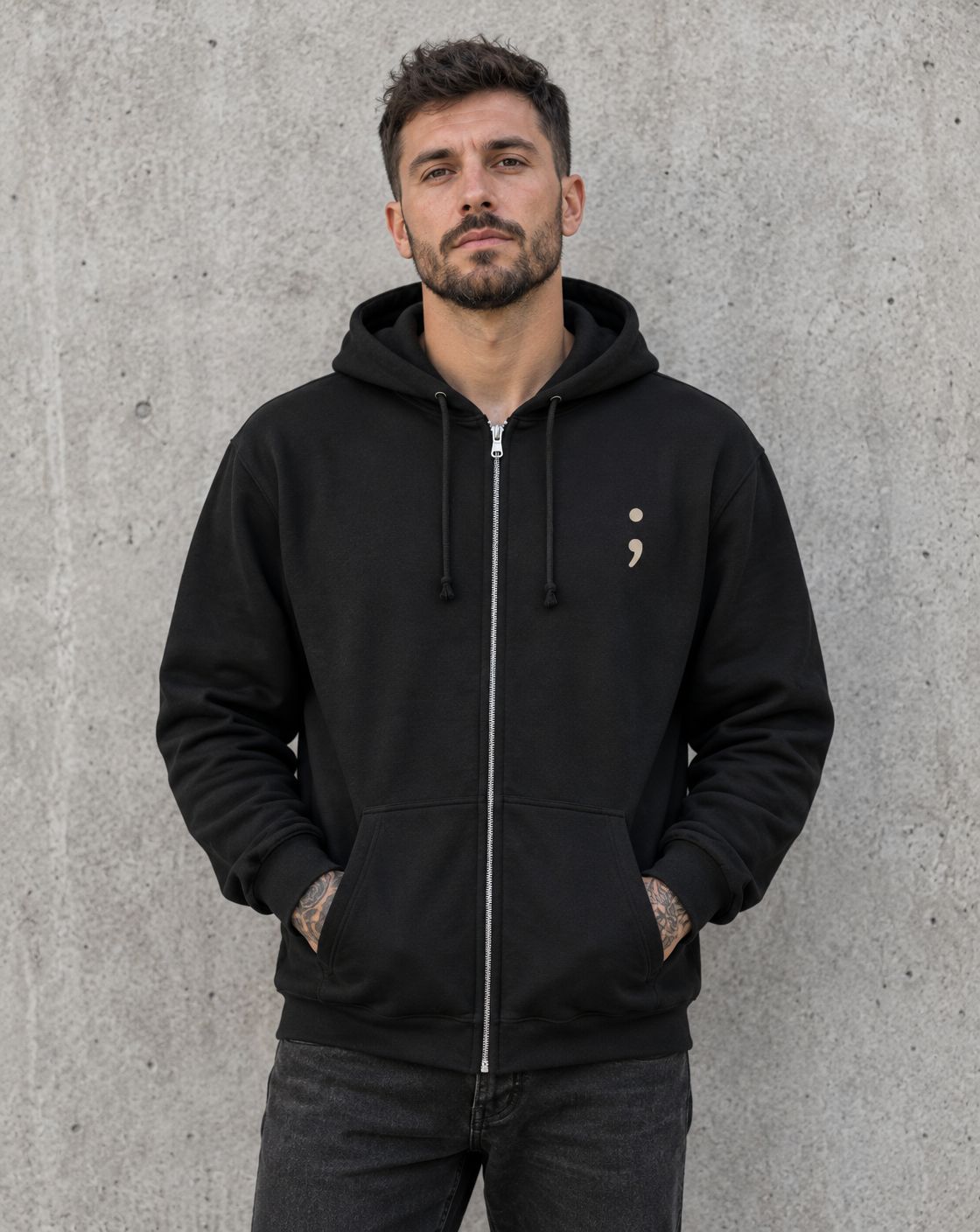 Model wearing the black I Got Your Six zip up hoodie, front view with small semicolon