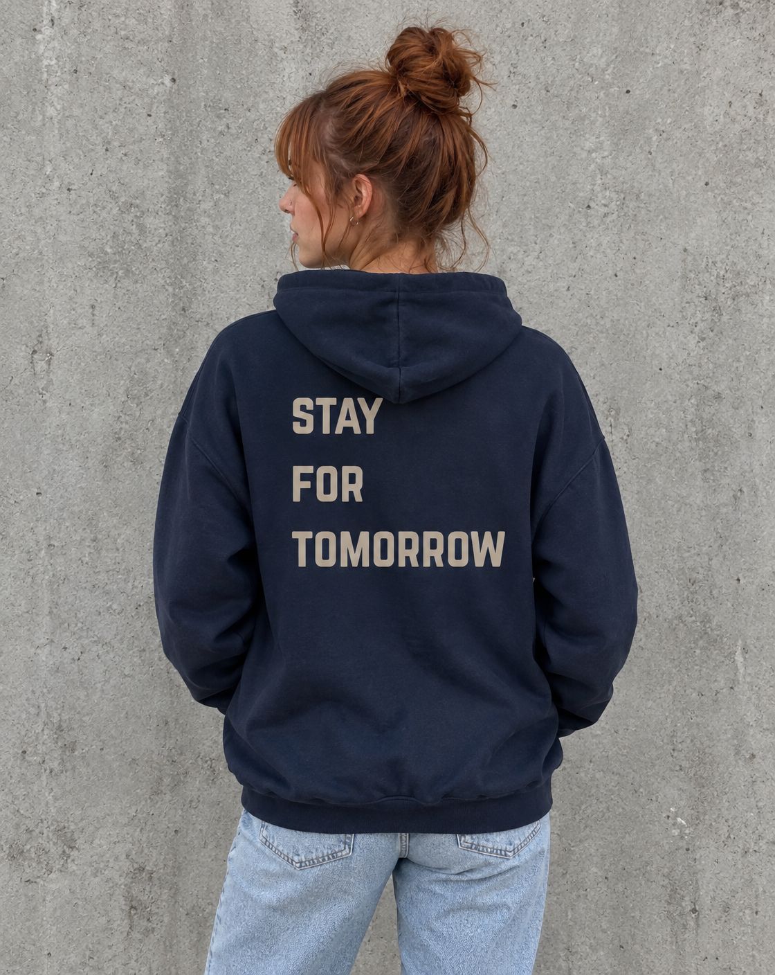Model wearing the navy Stay for Tomorrow suicide awareness zip up hoodie, back view