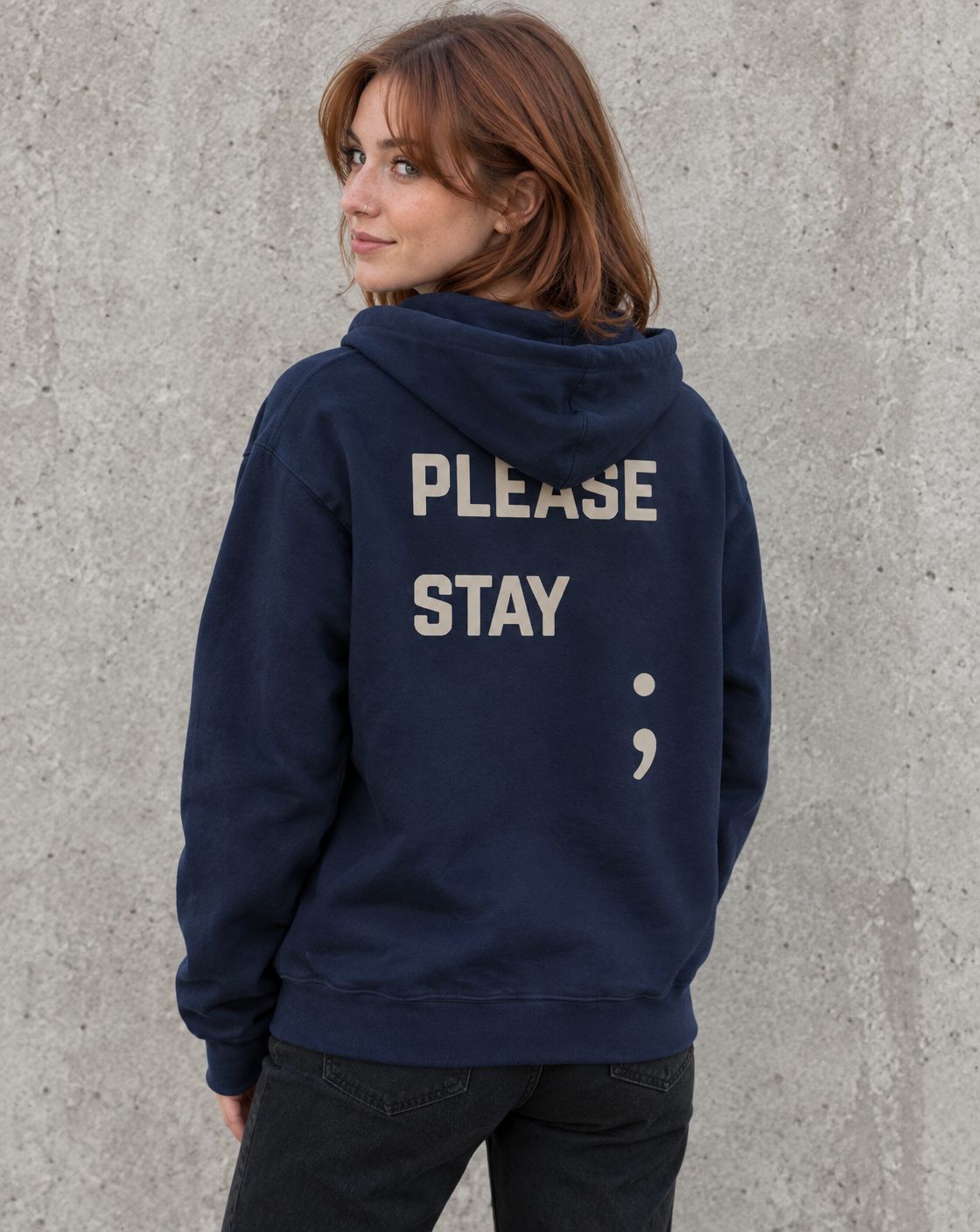 Model wearing the navy Please Stay; suicide awareness zip up hoodie, back view