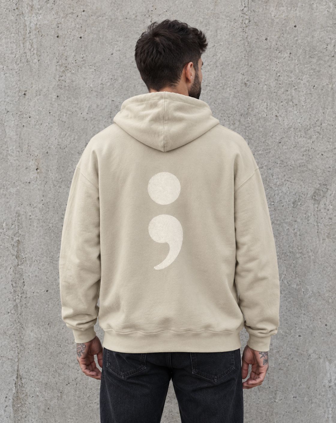 Model wearing the sand oversized semicolon suicide awareness pullover hoodie, back view