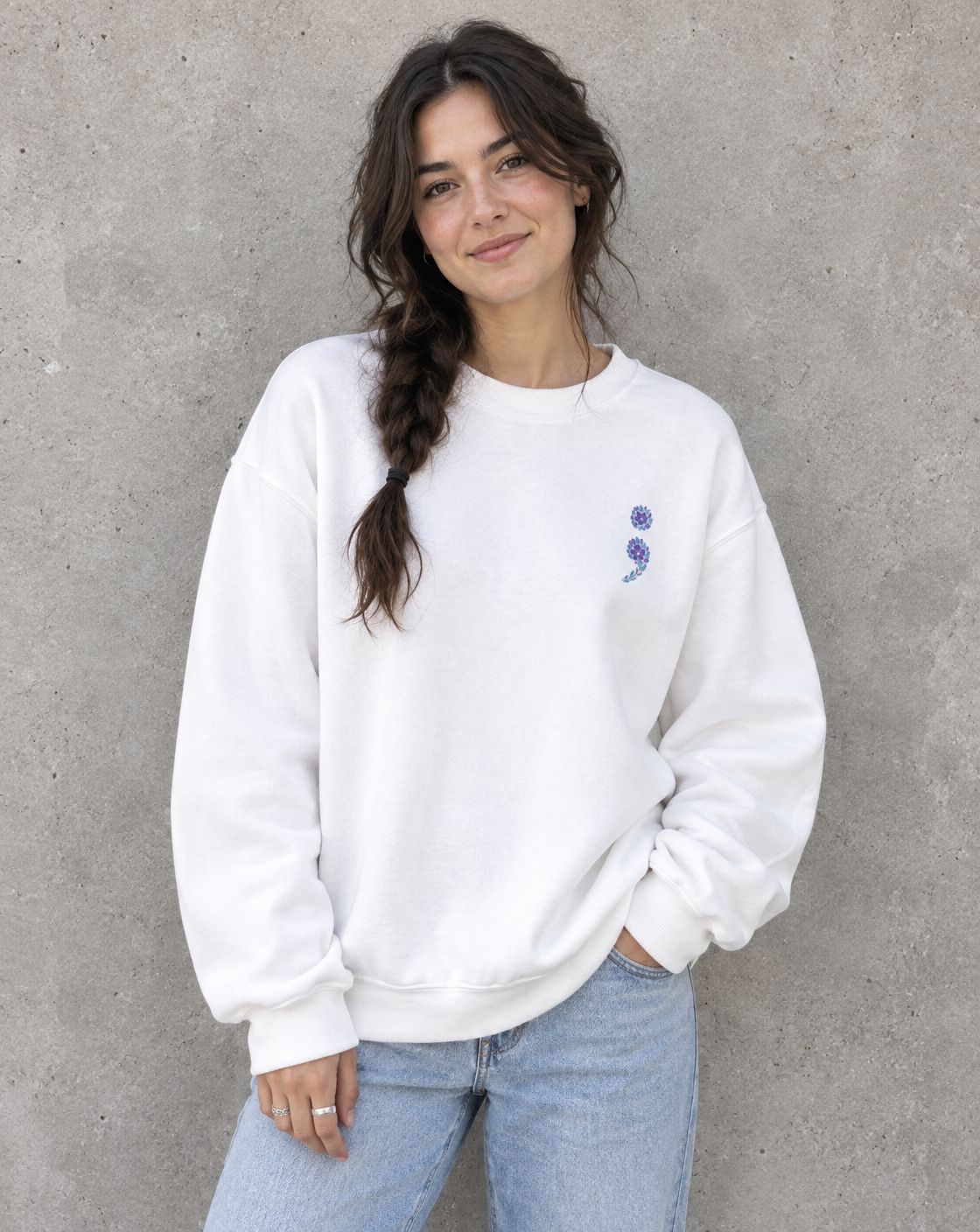 Model wearing the white purple and teal flag semicolon crewneck sweatshirt, front view