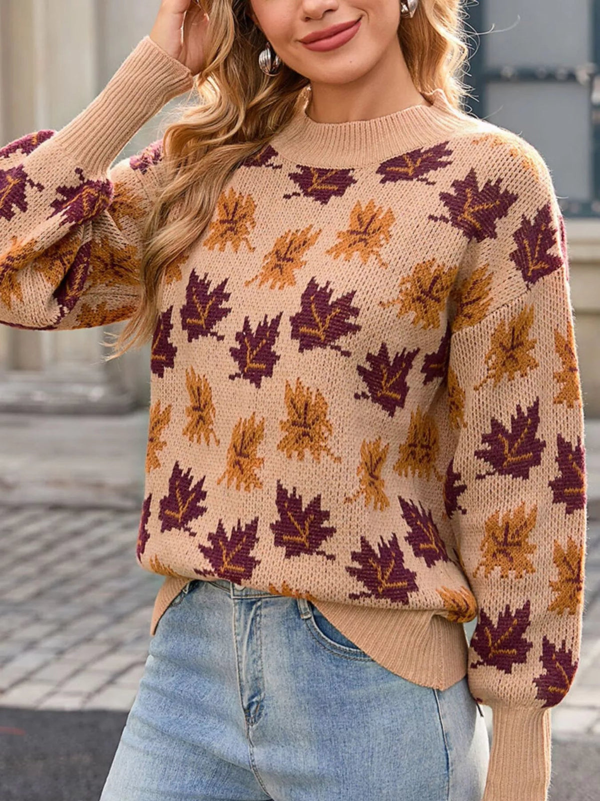 Wicked Thread Society mock neck sweater in beige with a purple and orange autumn leaf pattern, worn with jeans.