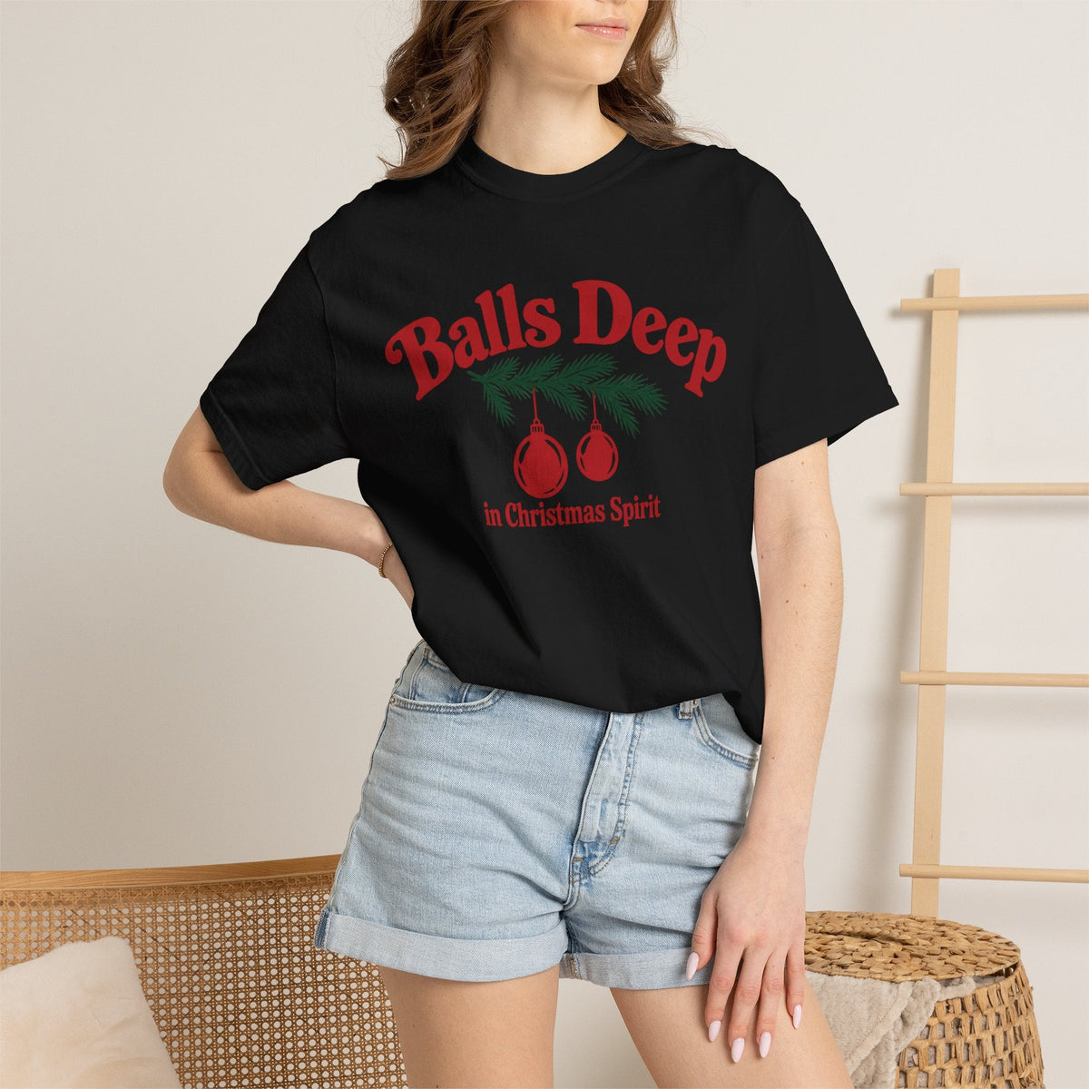 Wicked Thread Society black graphic t-shirt with red Christmas ornaments and pine branch design on a woman