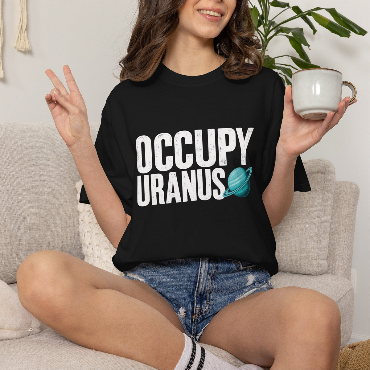 Wicked Thread Society black heavyweight cotton graphic tee with Occupy Uranus text and teal planet icon on a woman