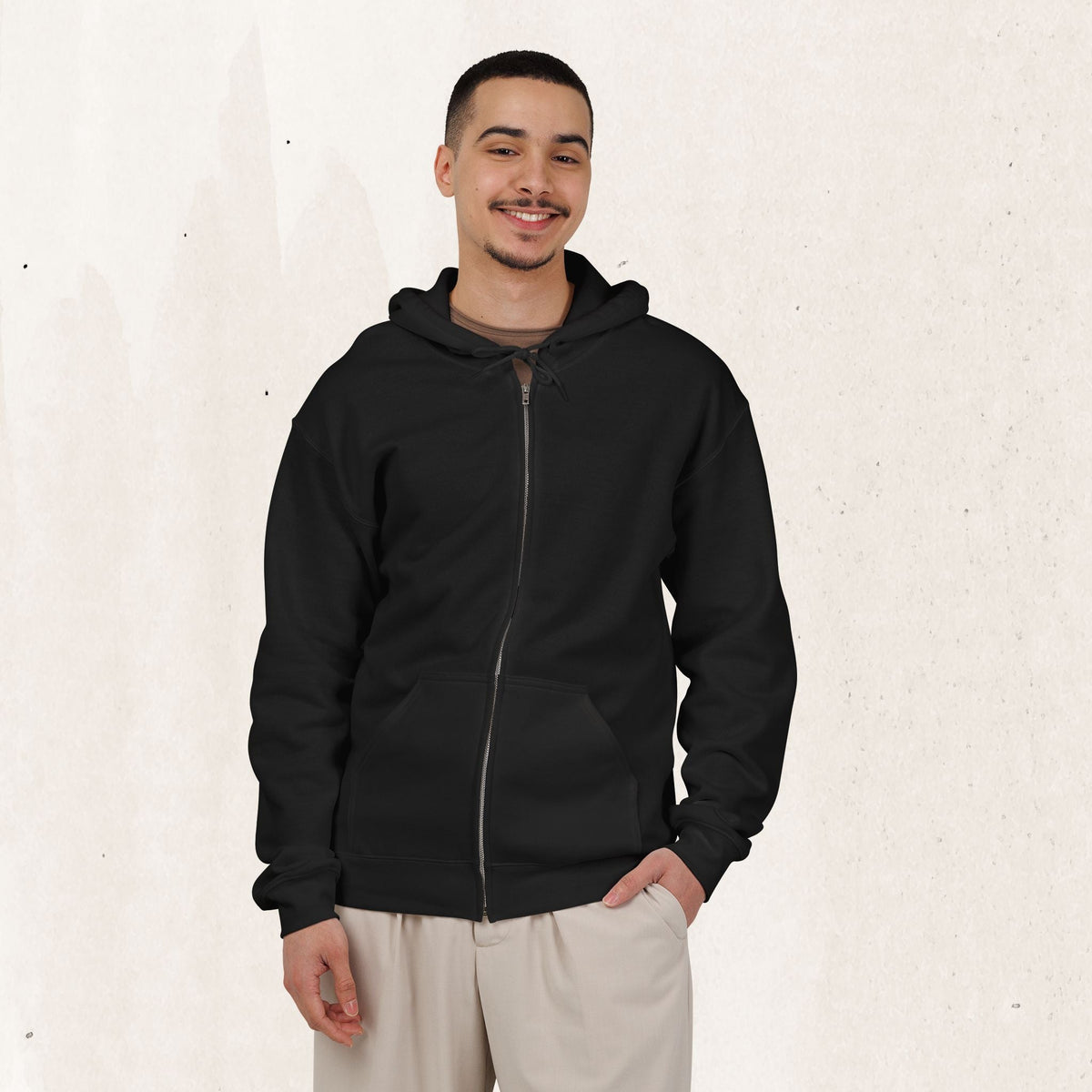 Wicked Thread Society black zip-up hoodie worn by a smiling man with a beard against a textured cream background