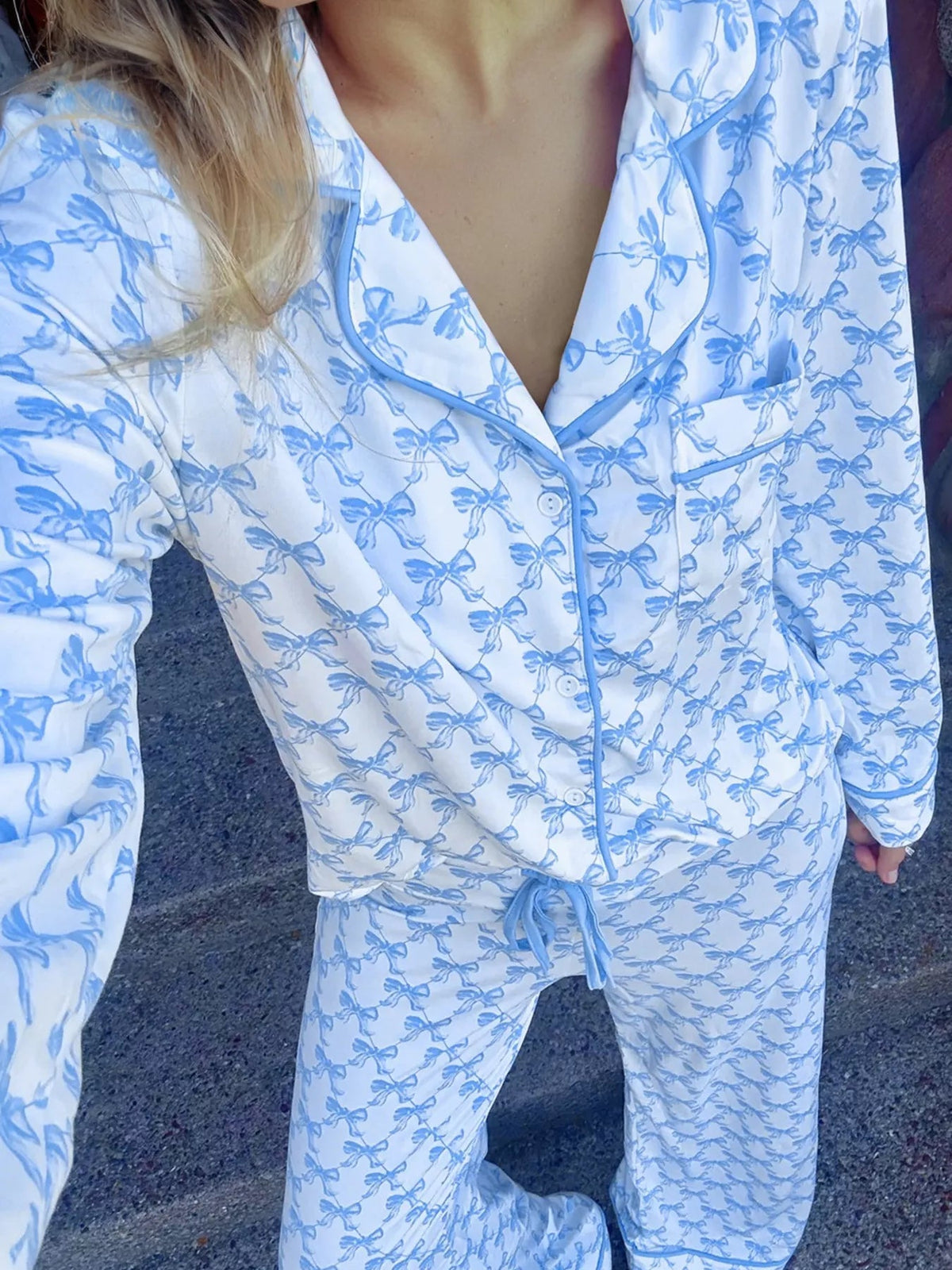 Wicked Thread Society two-piece pajama set featuring a white long-sleeve button-down shirt and pants with blue bows.