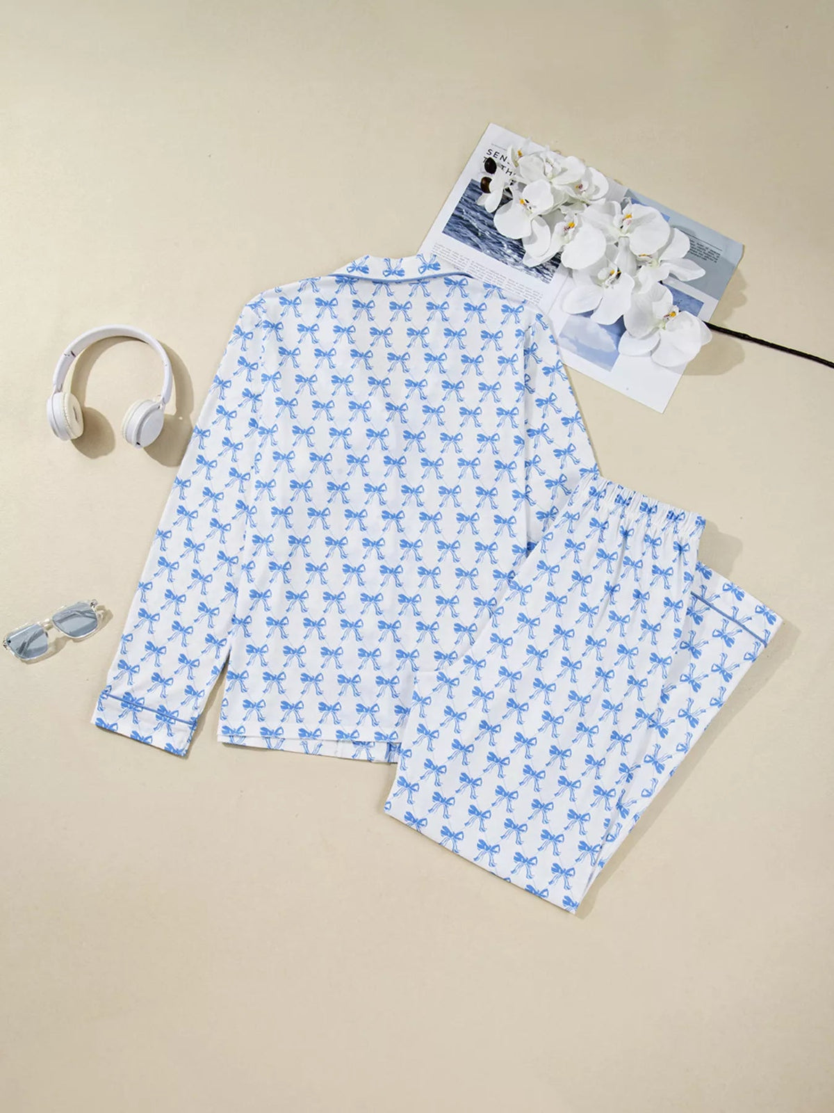 Wicked Thread Society two-piece pajama set with blue bow print on white polyester fabric, featuring buttoned top.