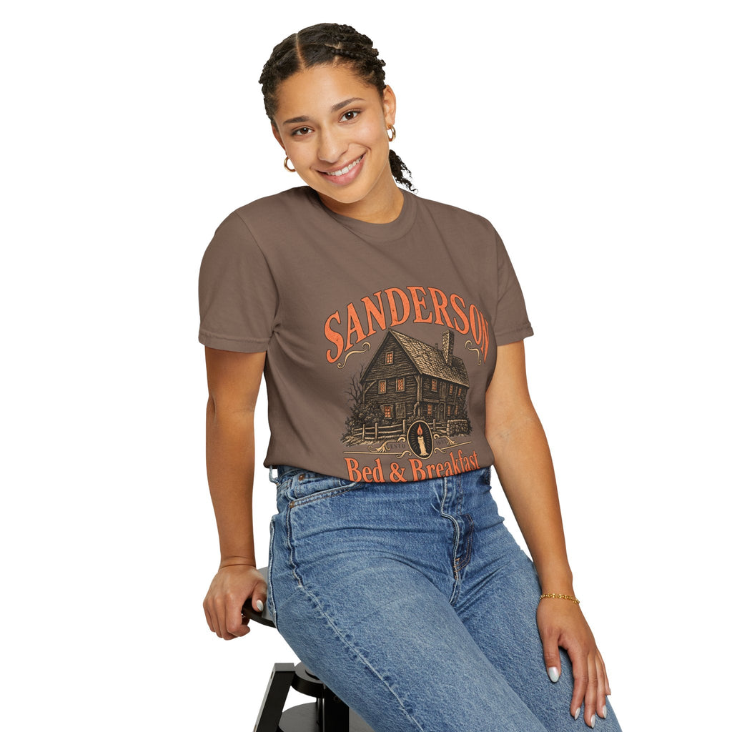 A smiling woman wears a Wicked Thread Society brown heavyweight cotton tee with a vintage Victorian house graphic.
