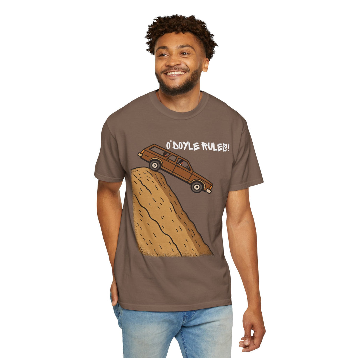 A smiling man wearing a Wicked Thread Society brown heavyweight cotton graphic tee featuring an O'Doyle Rules wagon.