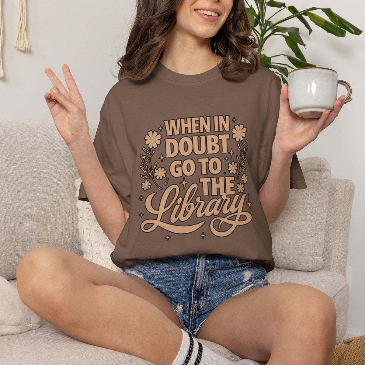 Wicked Thread Society brown graphic tee with When in Doubt Go to the Library text and floral art on a seated woman.