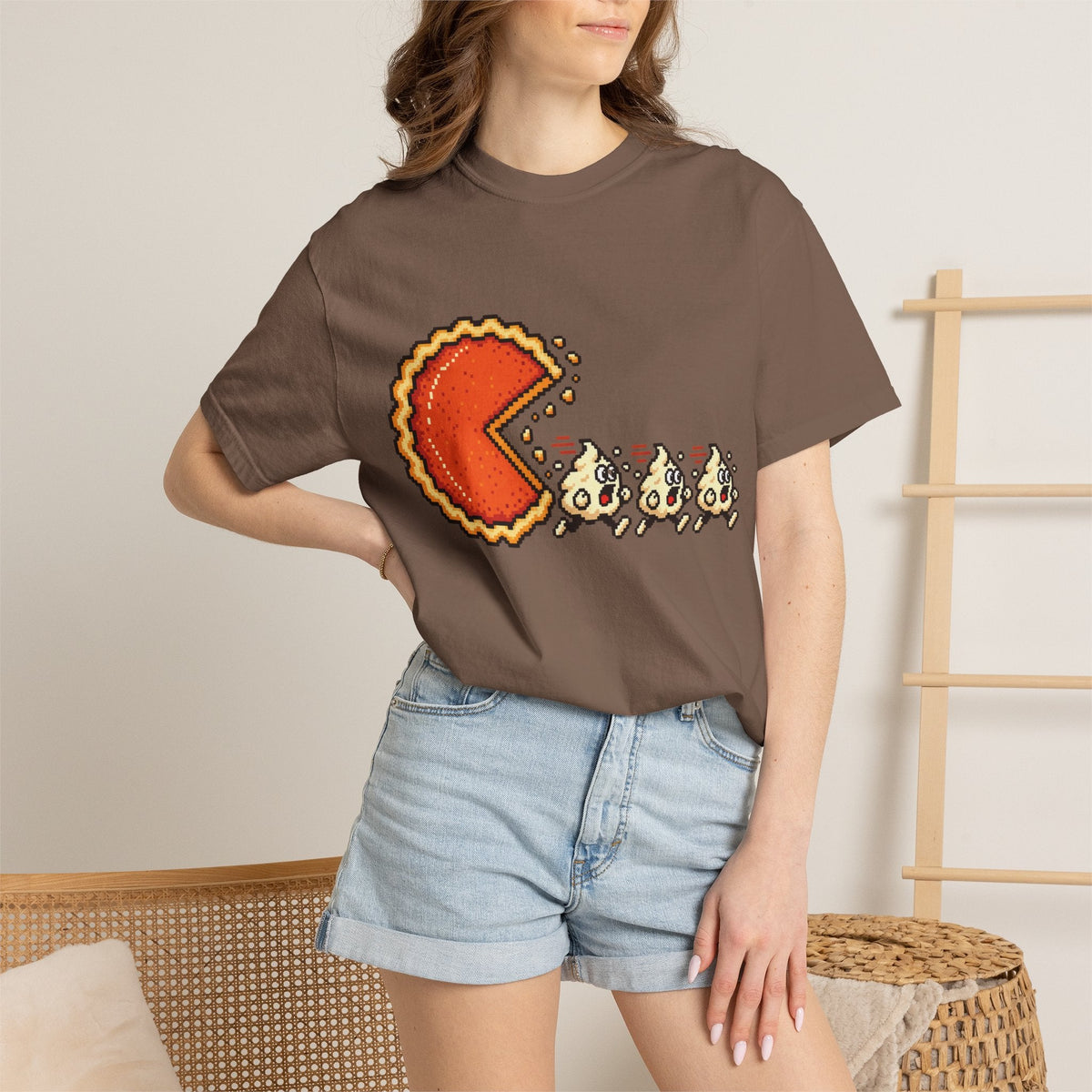 Wicked Thread Society brown graphic t-shirt featuring a pixel art pumpkin pie chasing whipped cream ghosts