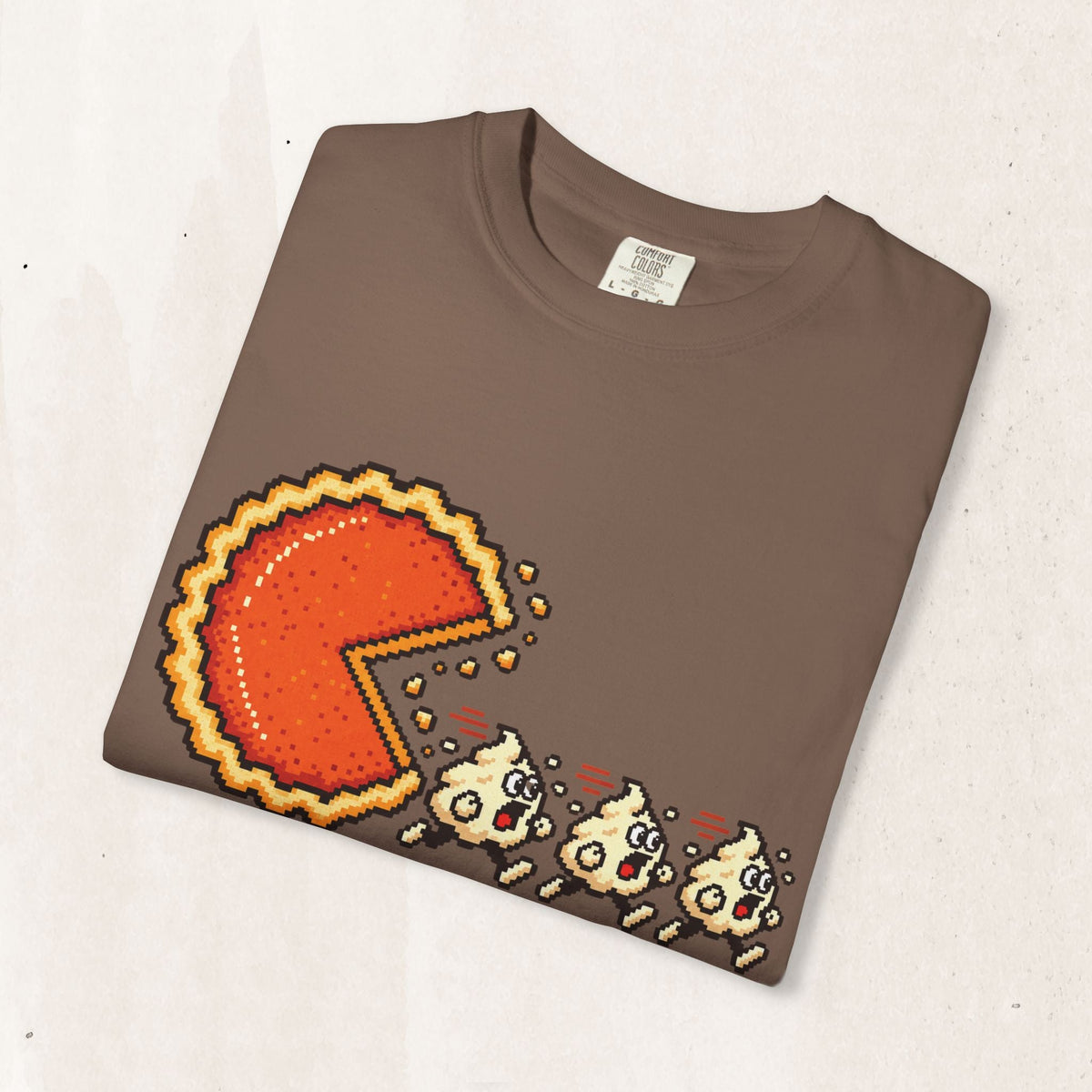Wicked Thread Society brown graphic t-shirt featuring a pixel art pumpkin pie chasing whipped cream ghosts