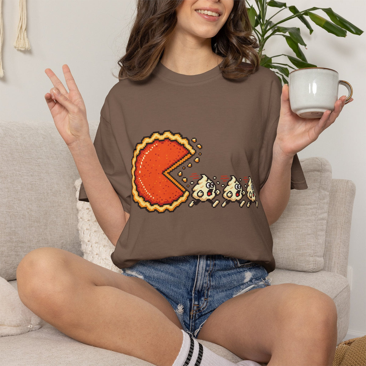 Wicked Thread Society brown graphic t-shirt featuring a pixel art pumpkin pie chasing whipped cream ghosts