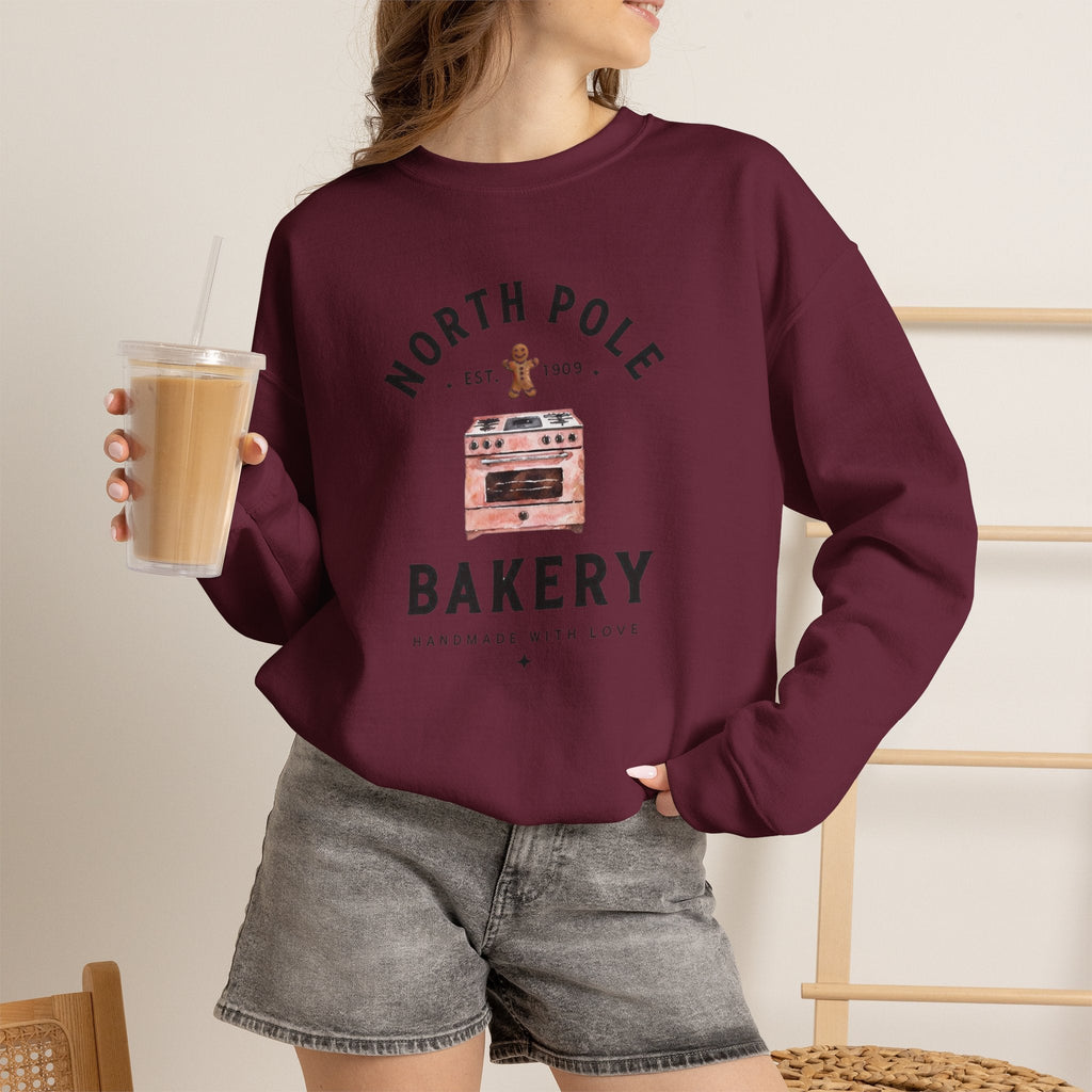Wicked Thread Society burgundy crewneck sweatshirt with a vintage North Pole Bakery oven and gingerbread man graphic.
