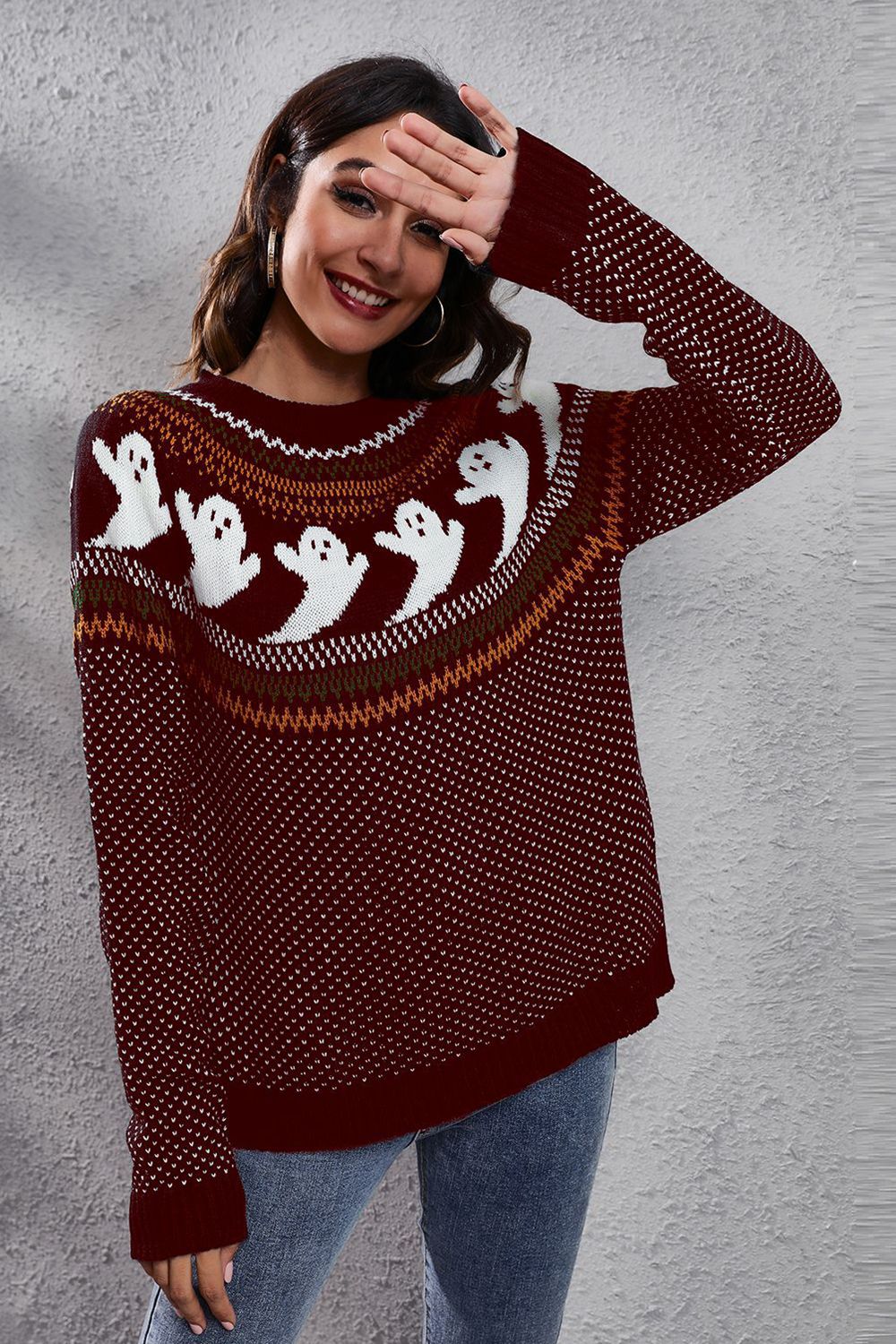 Wicked Thread Society burgundy long sleeve sweater with white ghost pattern and round neck worn by a smiling woman