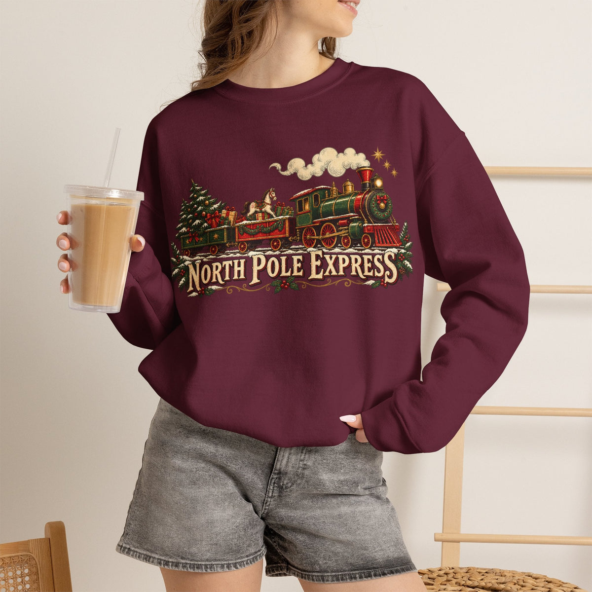 Wicked Thread Society burgundy crewneck sweatshirt featuring a vintage North Pole Express steam train holiday graphic.