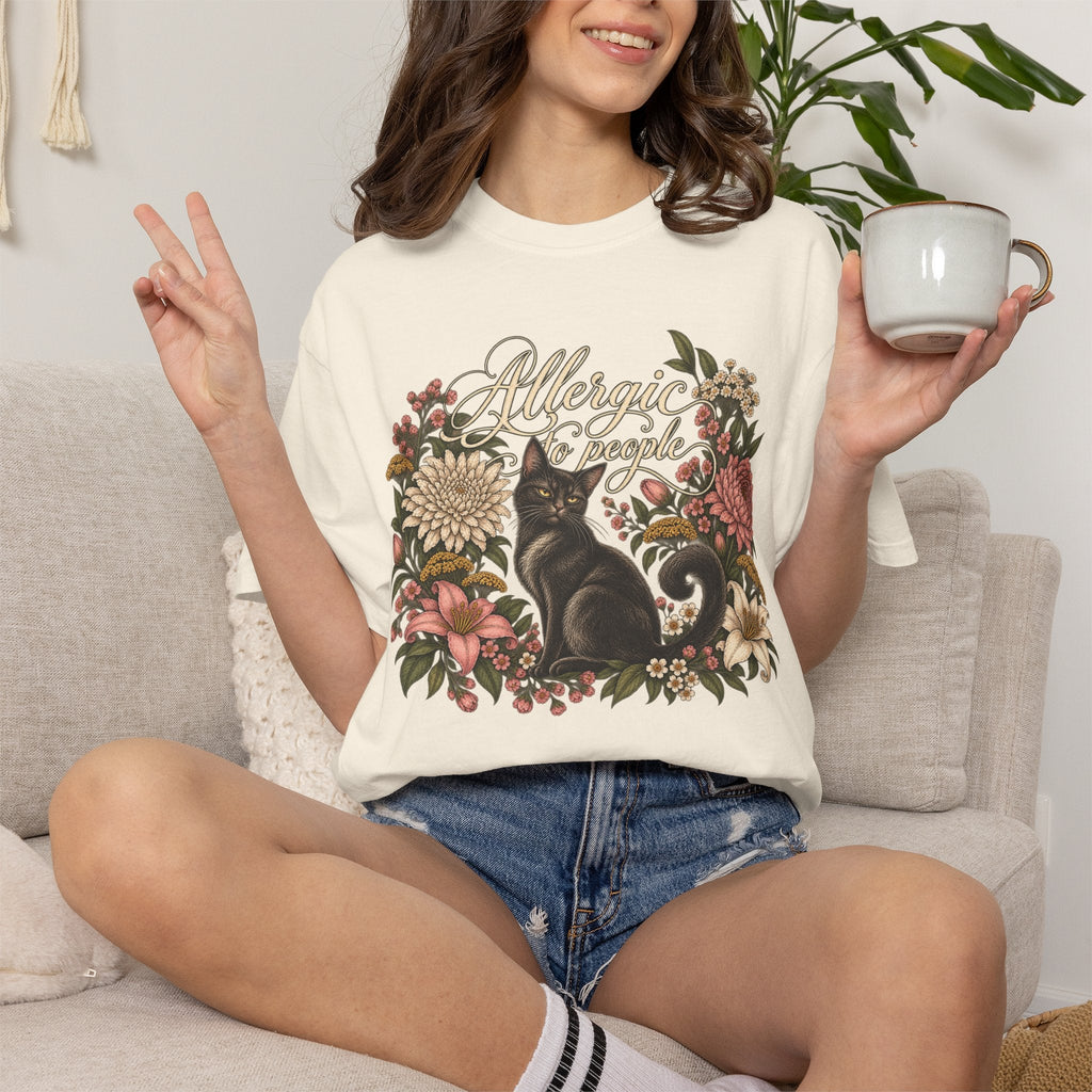 Wicked Thread Society cream t-shirt with black cat and floral wreath graphic worn by a woman holding a coffee mug