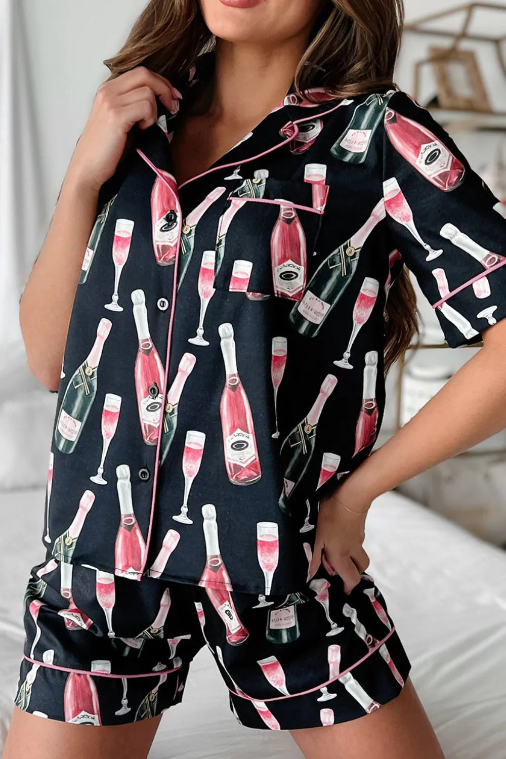 Wicked Thread Society black pajama set with champagne bottle and flute print and vibrant pink piping detail.