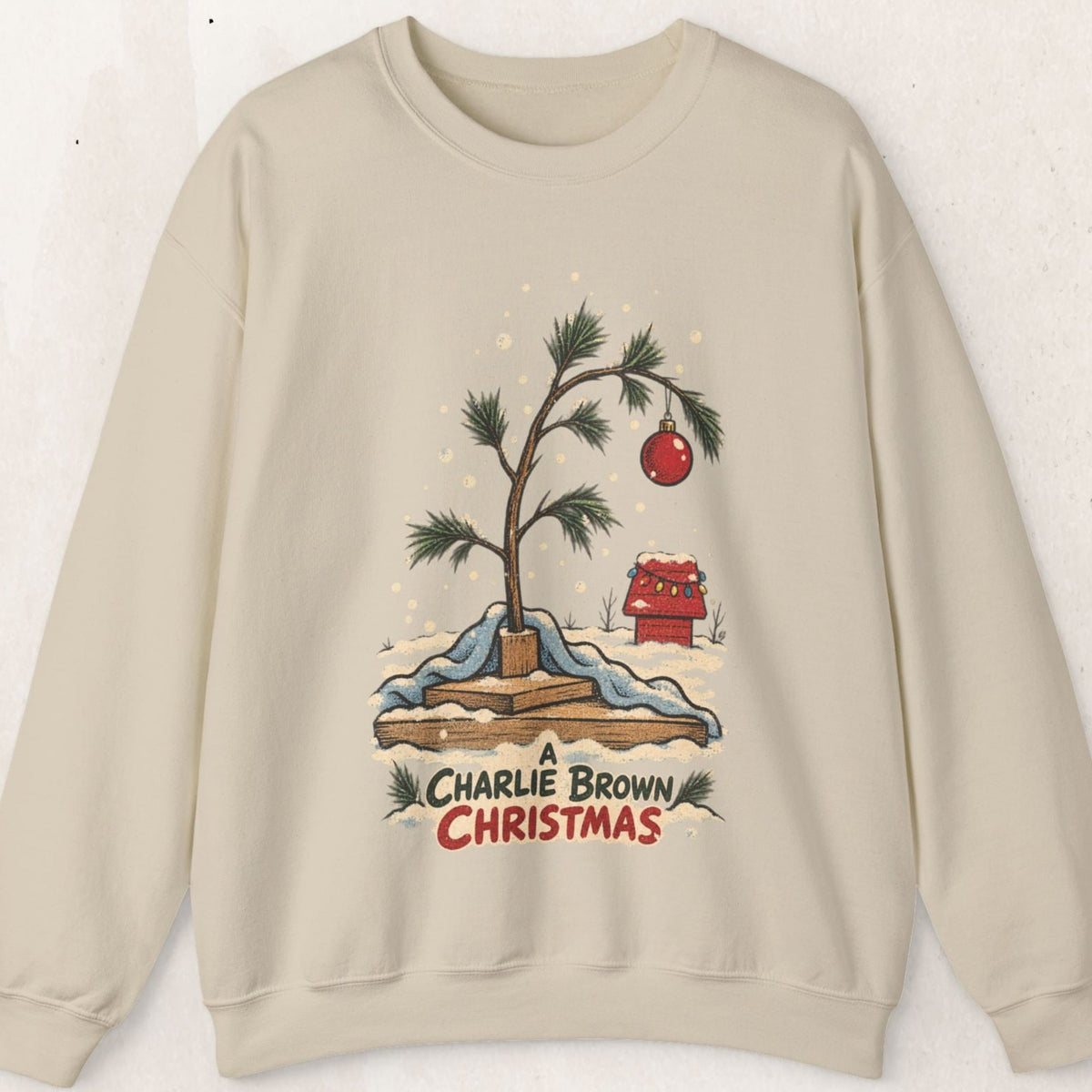 Wicked Thread Society beige crewneck sweatshirt featuring a hand-illustrated Charlie Brown Christmas tree graphic.