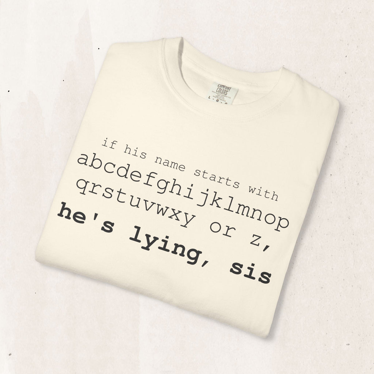 He's Lying, Sis T-shirt | Typographic alphabet humor tee Printify