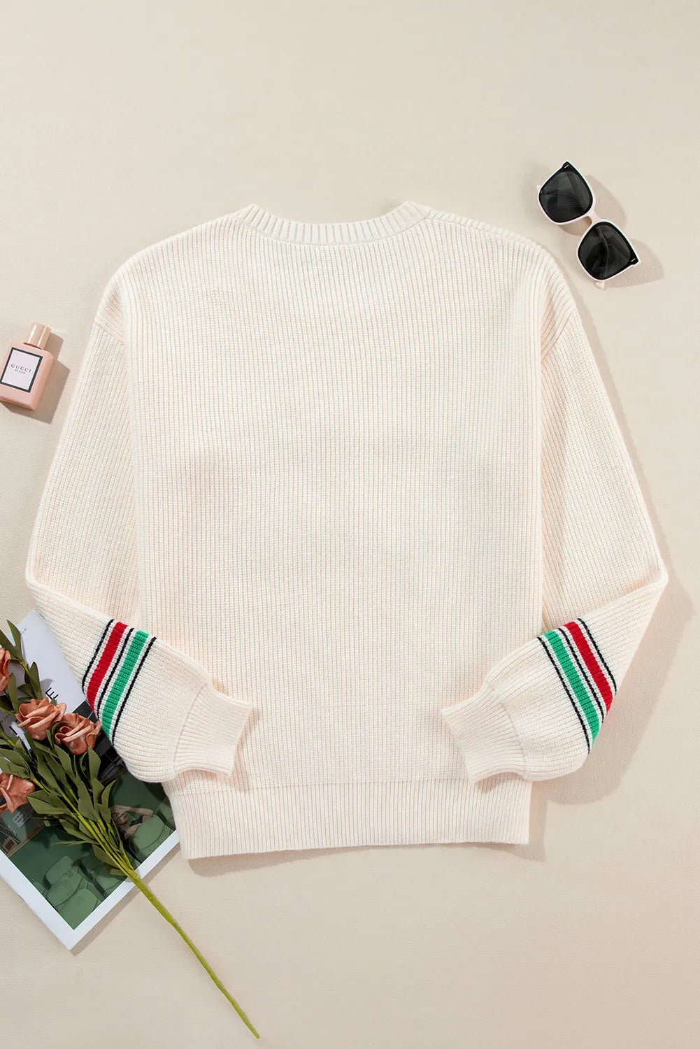 Wicked Thread Society cream ribbed long sleeve sweater with red and green striped cuffs on a flat lay background