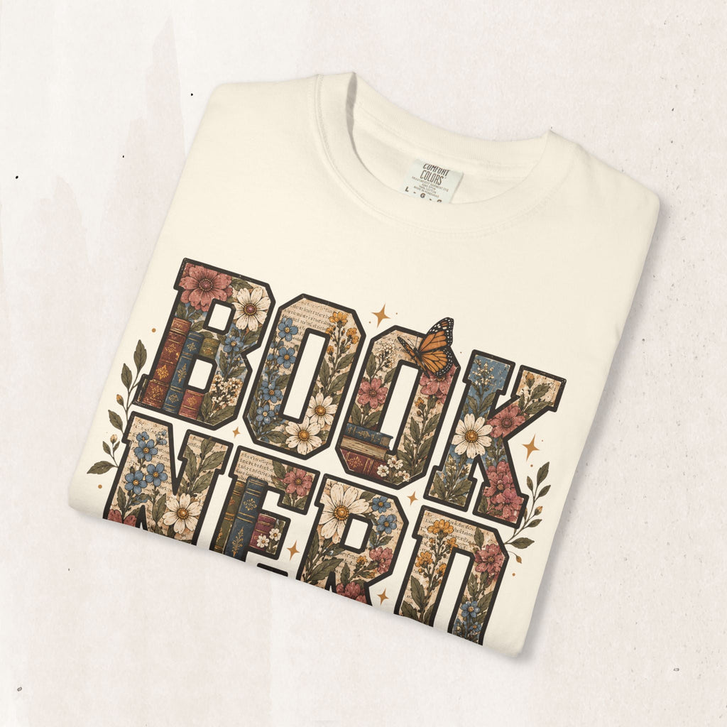 Wicked Thread Society cream graphic tee featuring floral BOOK NERD lettering with butterfly and book illustrations.