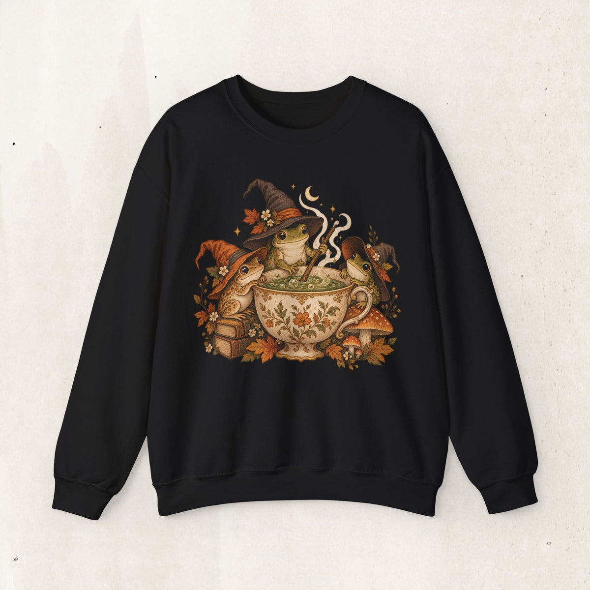 Wicked Thread Society black crewneck sweatshirt featuring a vintage illustration of frogs in witch hats with tea.