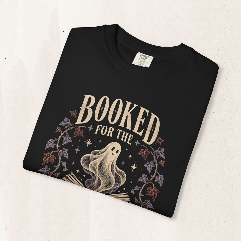 Wicked Thread Society faded black cotton t-shirt featuring a ghost rising from an open book with botanical accents.