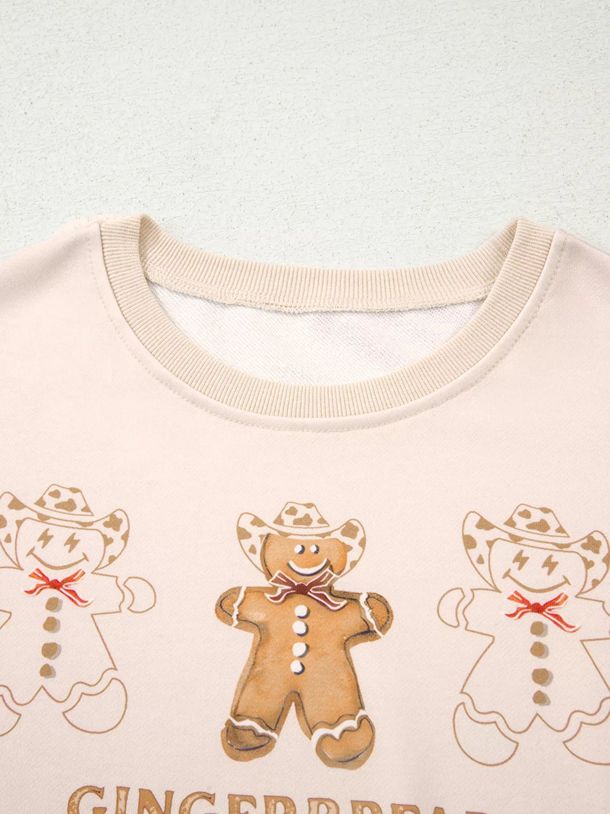 Wicked Thread Society beige long sleeve top featuring a festive gingerbread man print with cowboy hats
