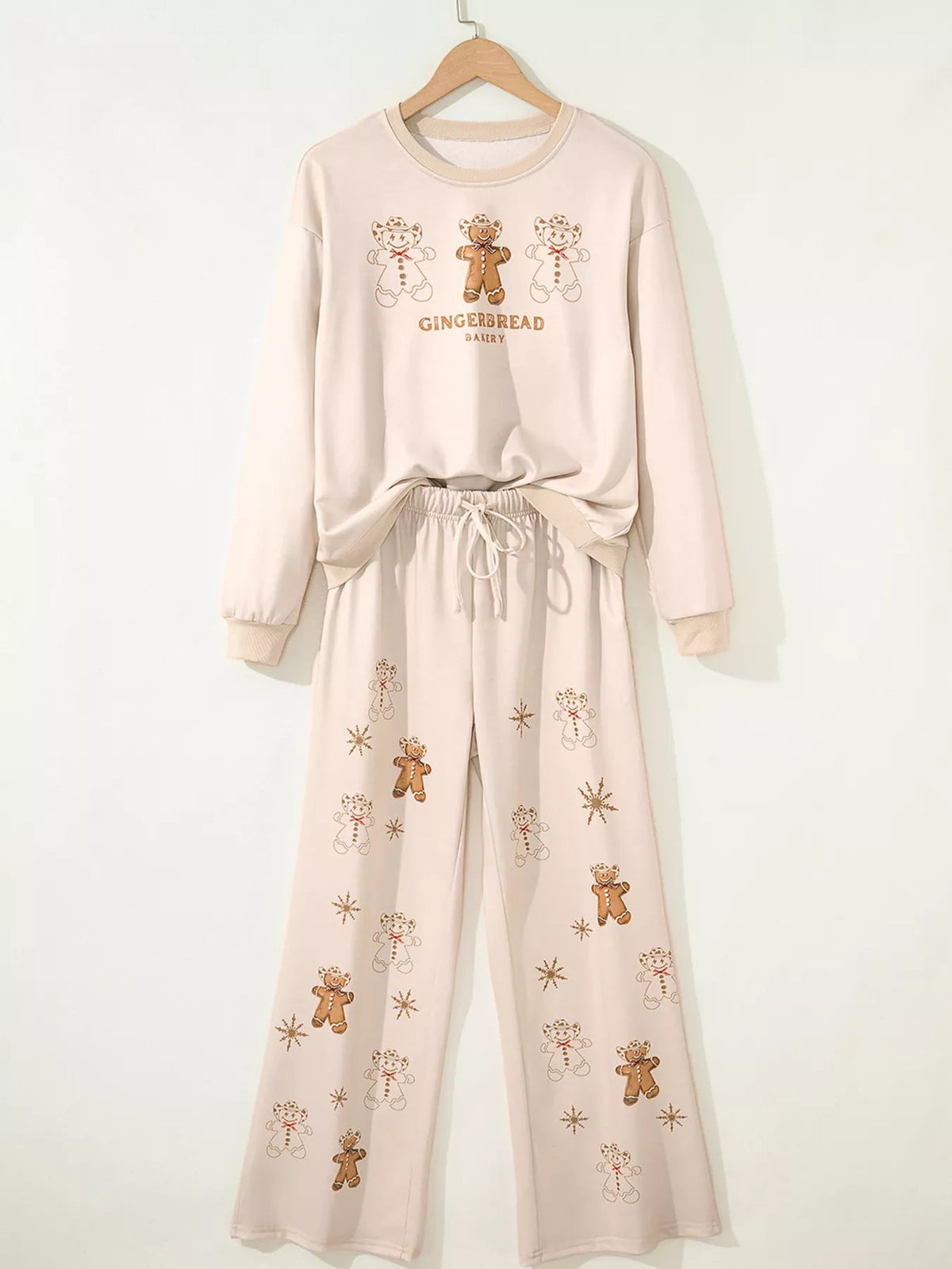 Wicked Thread Society two-piece gingerbread bakery pajama set with long sleeve top and drawstring pants in beige.