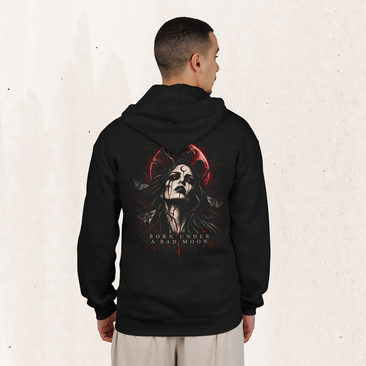 Wicked Thread Society black zip-up hoodie with a gothic Born Under A Bad Moon graphic on the back worn by a man