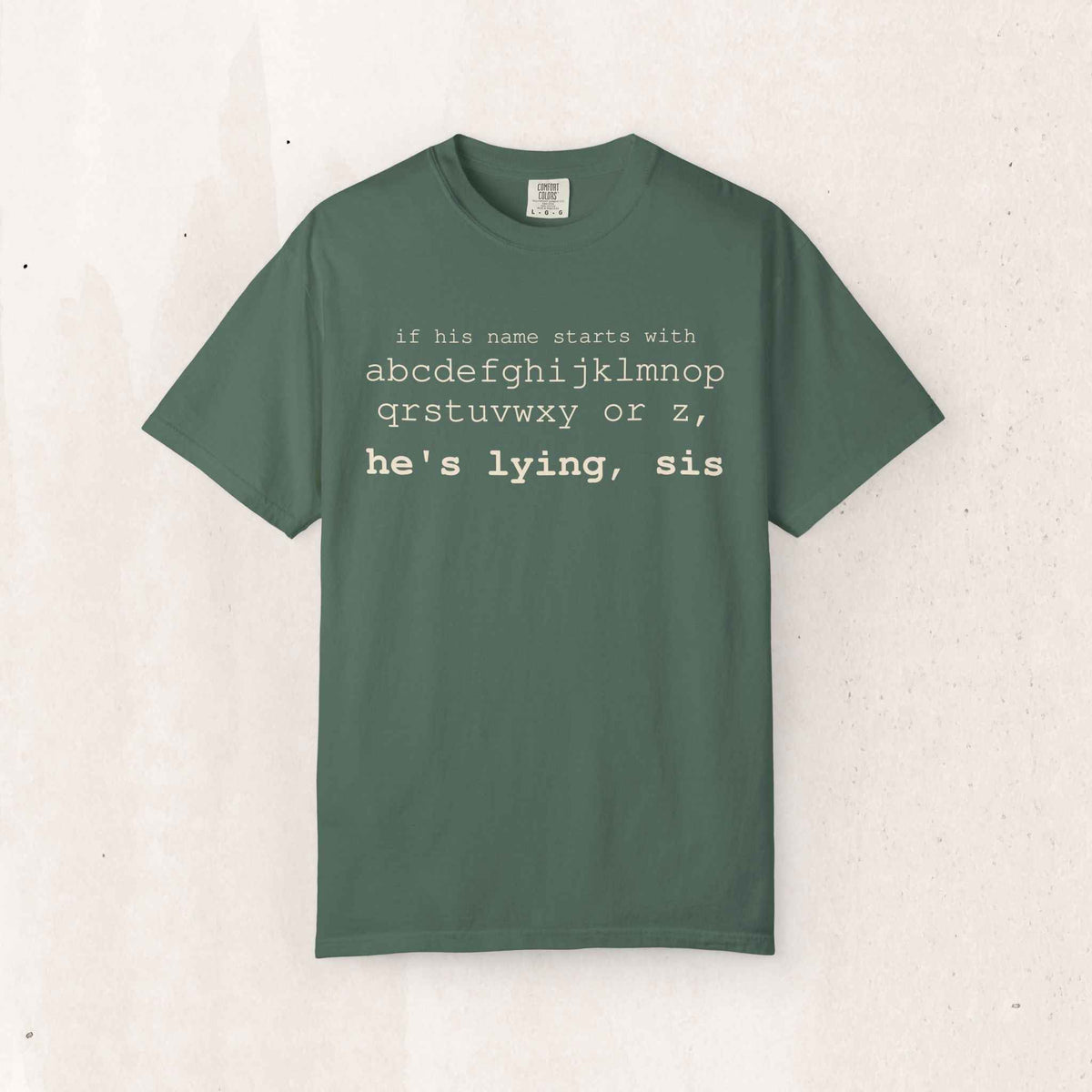 He's Lying, Sis Tee – Funny Alphabet Typography Shirt – Blue Spruce