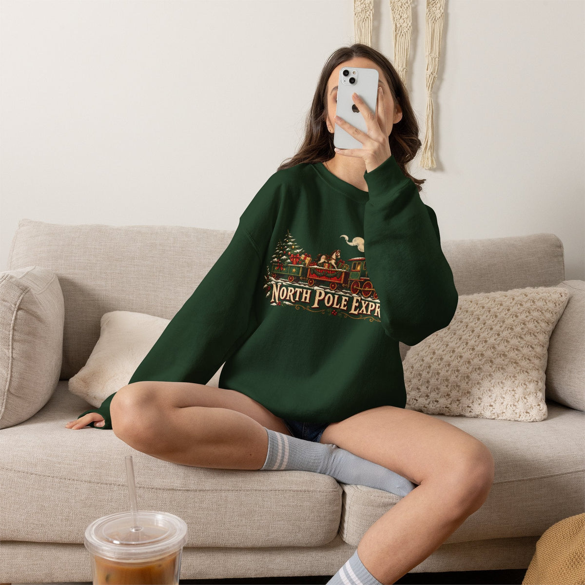 Wicked Thread Society dark green crewneck sweatshirt with a vintage North Pole Express train graphic on a woman