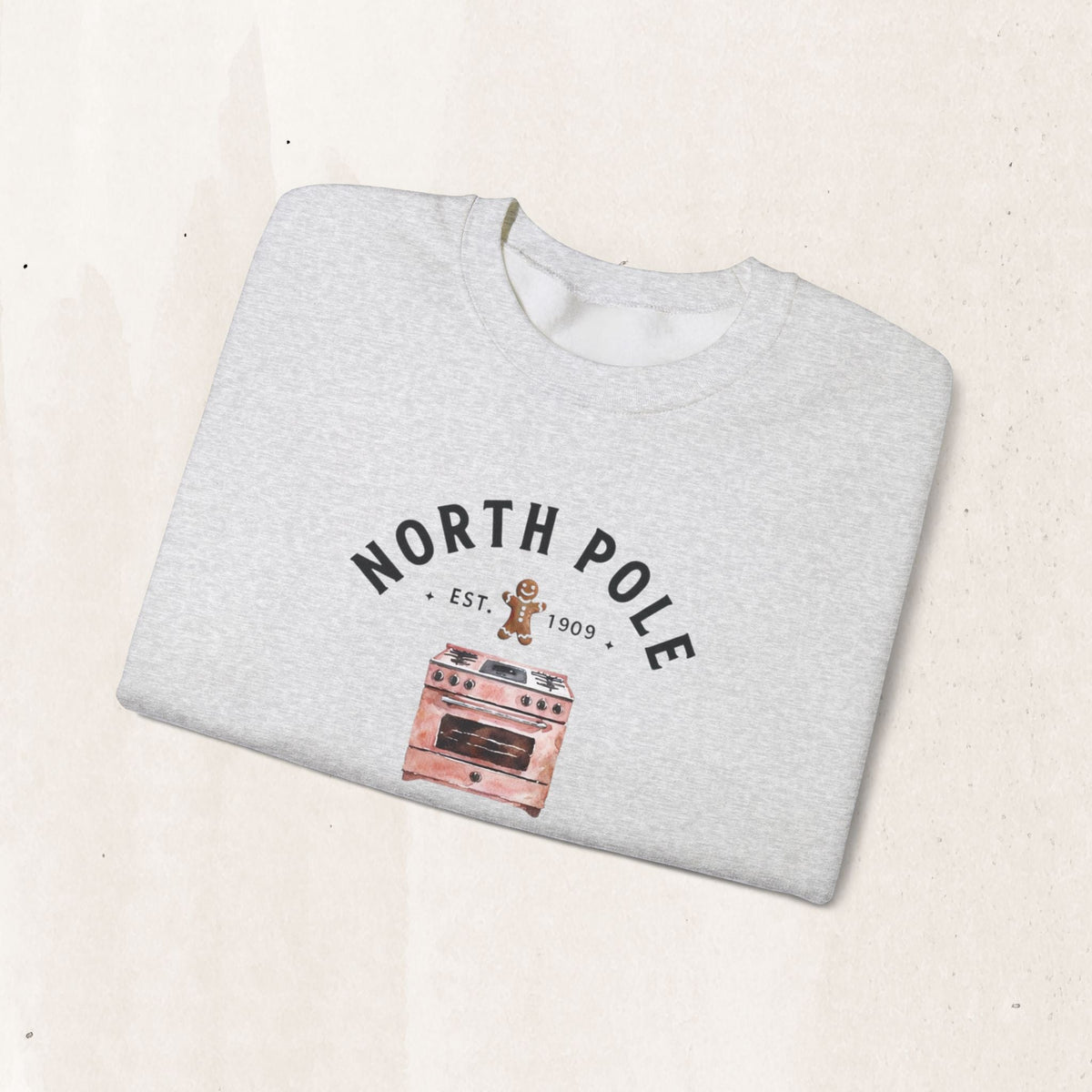 Wicked Thread Society grey crewneck sweatshirt with a North Pole Bakery oven and gingerbread man graphic.