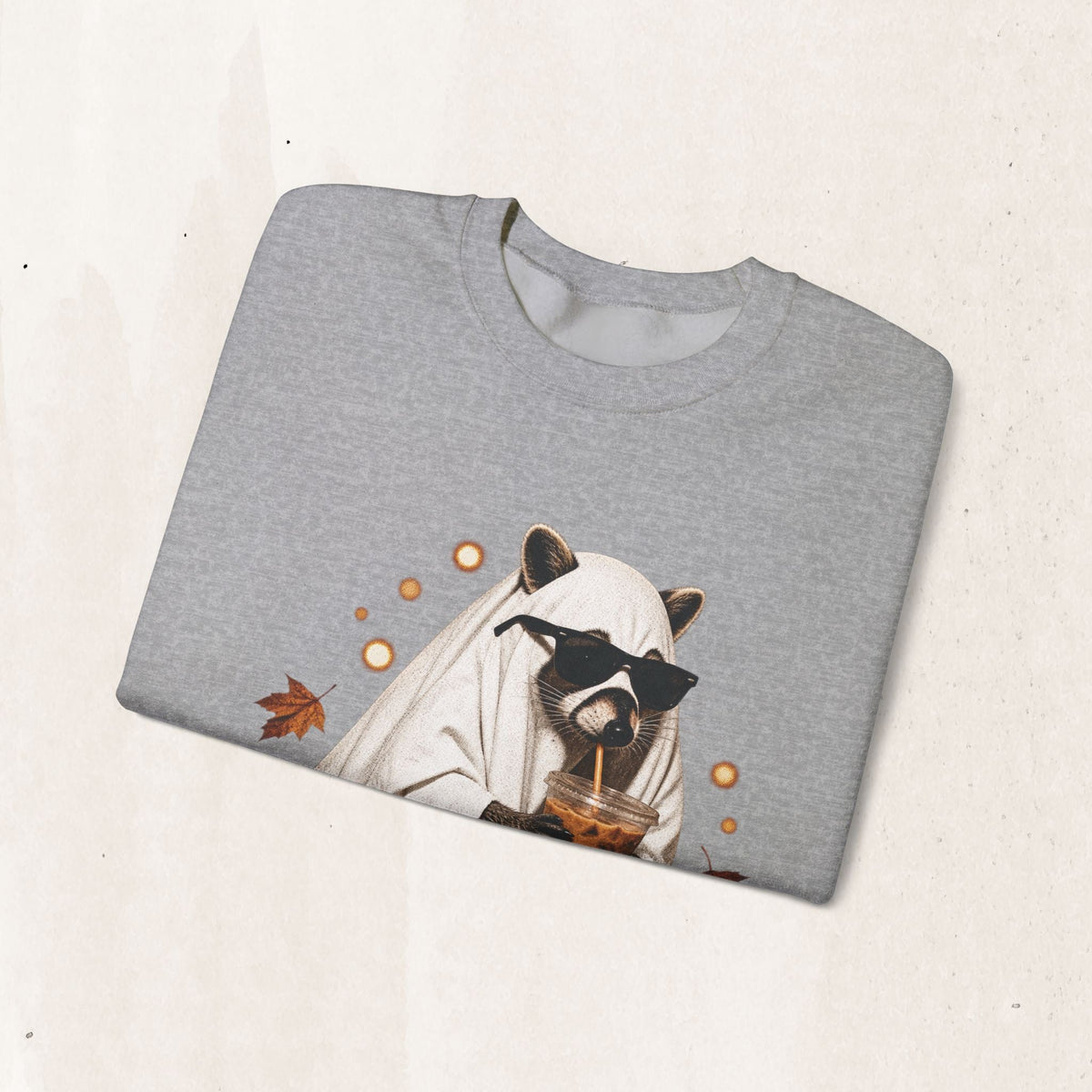 Wicked Thread Society grey crewneck sweatshirt featuring a raccoon in a ghost costume drinking boba with autumn leaves