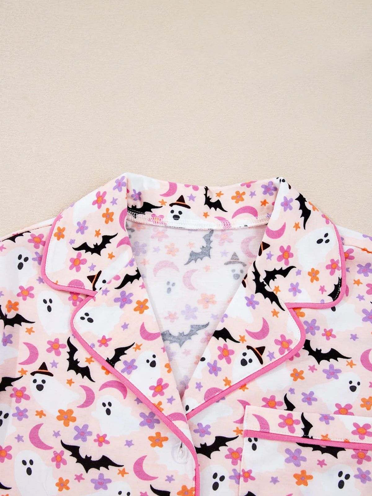 Wicked Thread Society button-up lounge top with pink piping and a playful Halloween ghost, bat, and floral print.