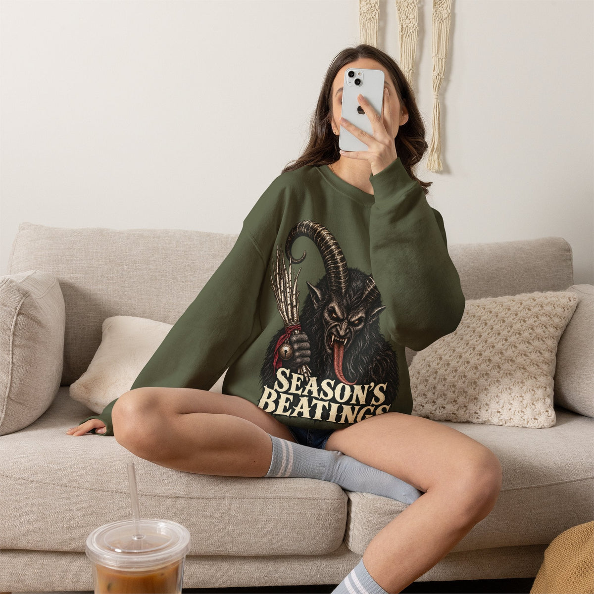 Wicked Thread Society olive green crewneck sweatshirt featuring a Krampus illustration and Seasons Beatings text.