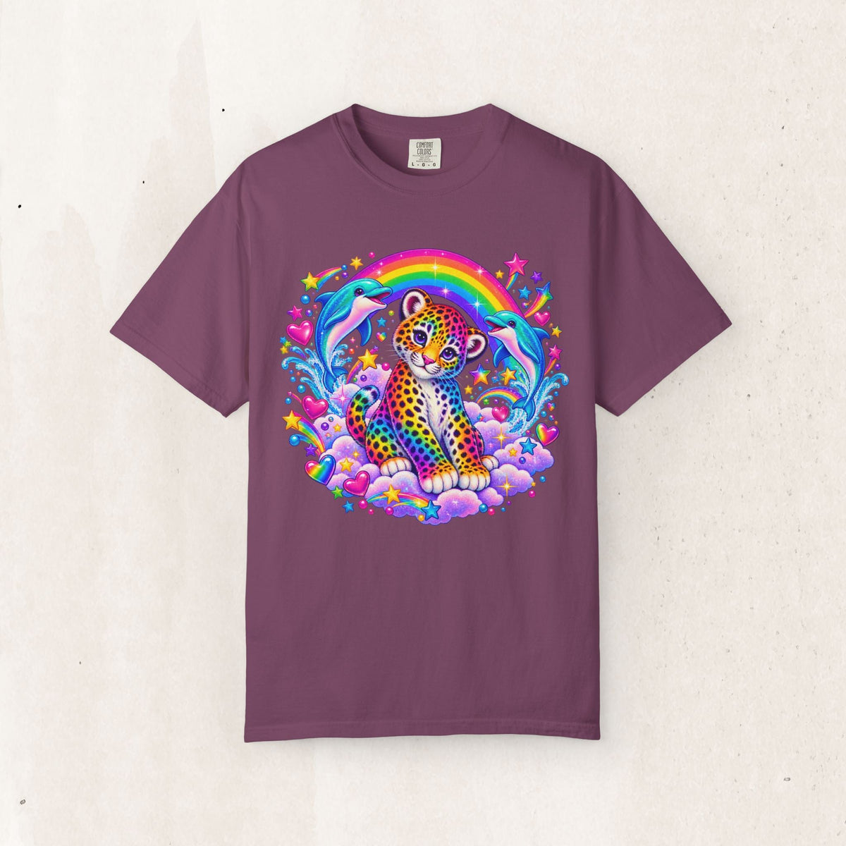 Wicked Thread Society garment-dyed purple cotton tee featuring a whimsical rainbow leopard, dolphins, and stars print.