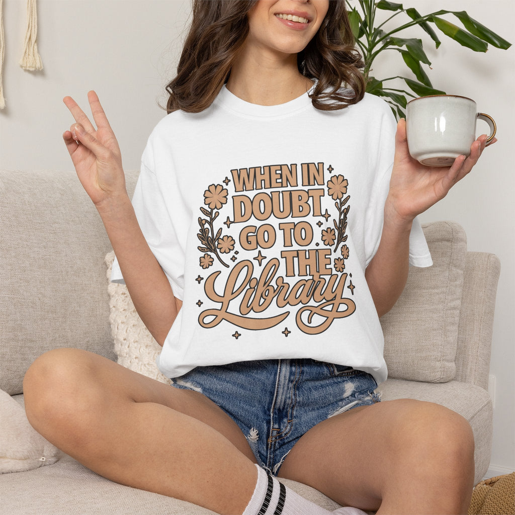 Wicked Thread Society white graphic tee with When in Doubt Go to the Library text, florals, and stars on a woman.