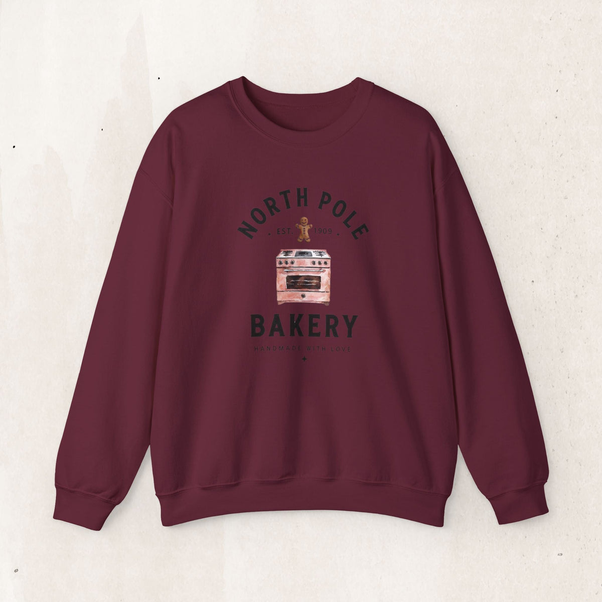 Wicked Thread Society maroon crewneck sweatshirt featuring a vintage North Pole Bakery oven and gingerbread man print.