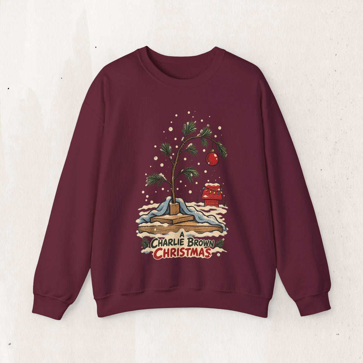 Wicked Thread Society maroon crewneck sweatshirt featuring a hand-illustrated Charlie Brown Christmas tree graphic.