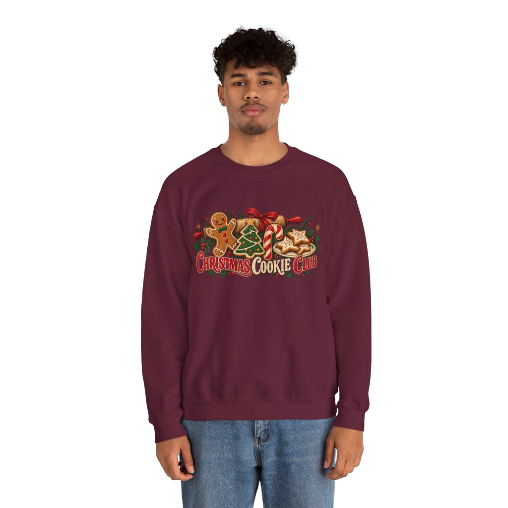 A man wearing a Wicked Thread Society maroon crewneck sweatshirt with a festive Christmas Cookie Club graphic print.