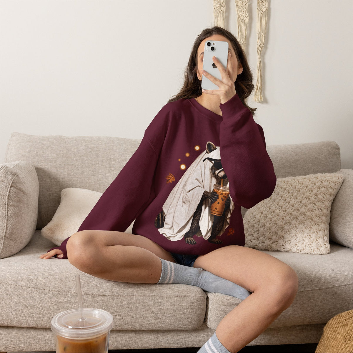 Wicked Thread Society maroon crewneck sweatshirt featuring a cute raccoon in a ghost costume holding a boba tea.