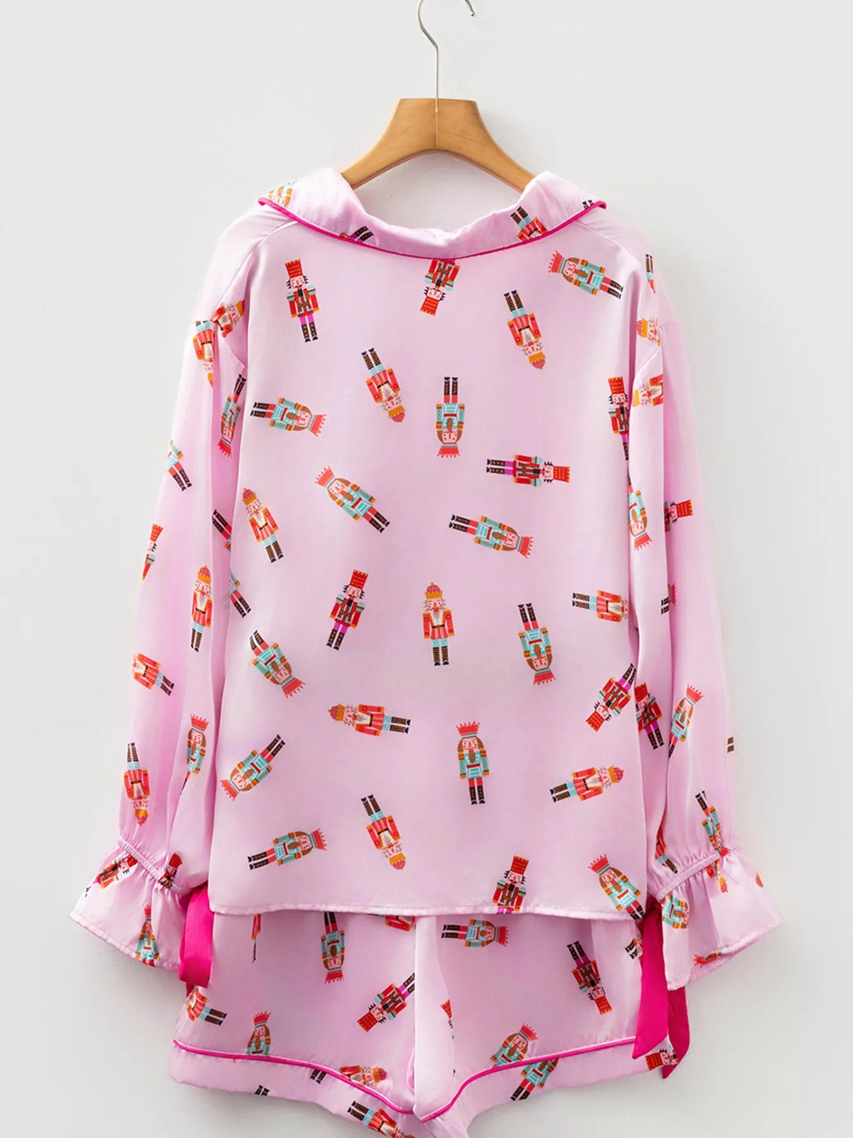 Wicked Thread Society pink pajama set with nutcracker print, contrast trim, button-down top, and ruffled sleeves.
