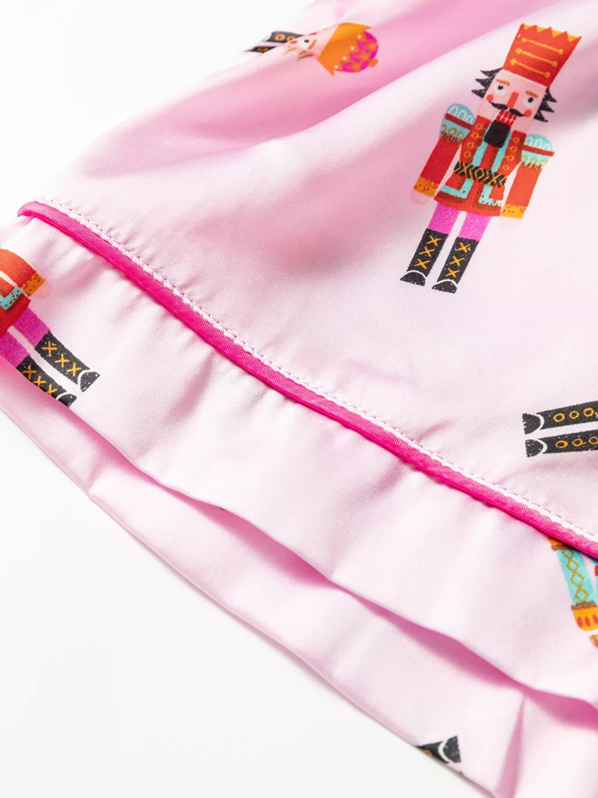 Wicked Thread Society pink pajama shorts with a festive nutcracker print and contrast piping trim