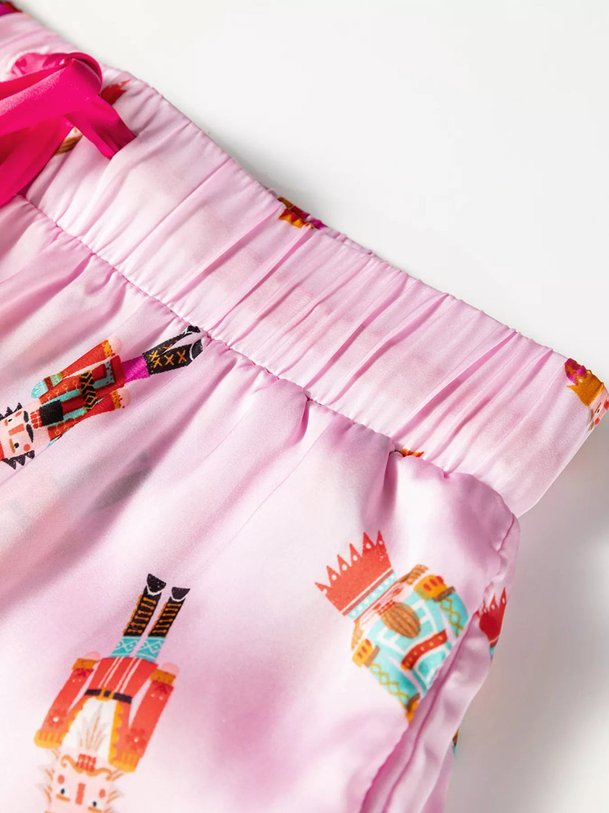 Wicked Thread Society pink pajama shorts with a festive nutcracker print and a bright pink satin drawstring waist.