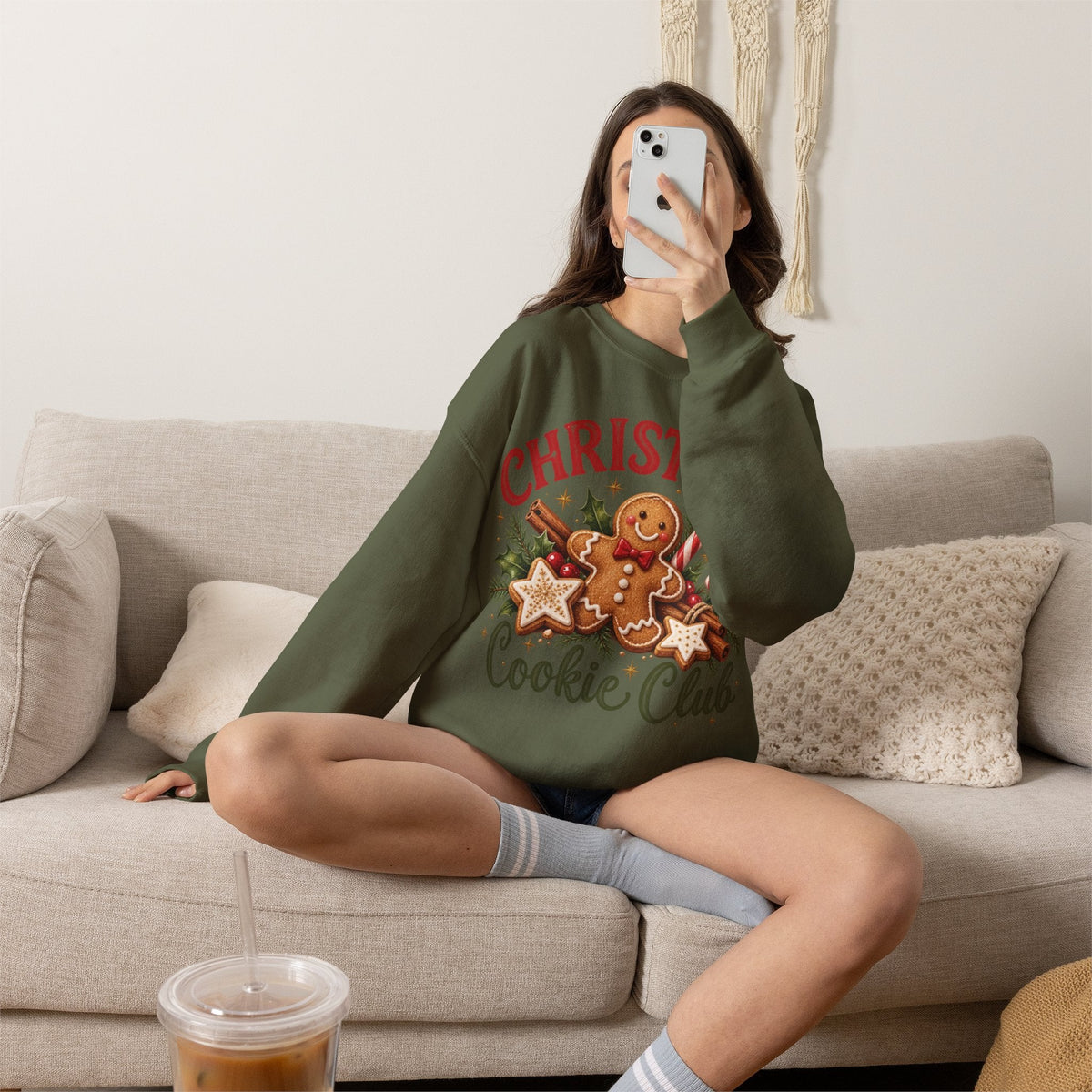 Wicked Thread Society olive green crewneck sweatshirt with a gingerbread man Christmas graphic worn by a woman