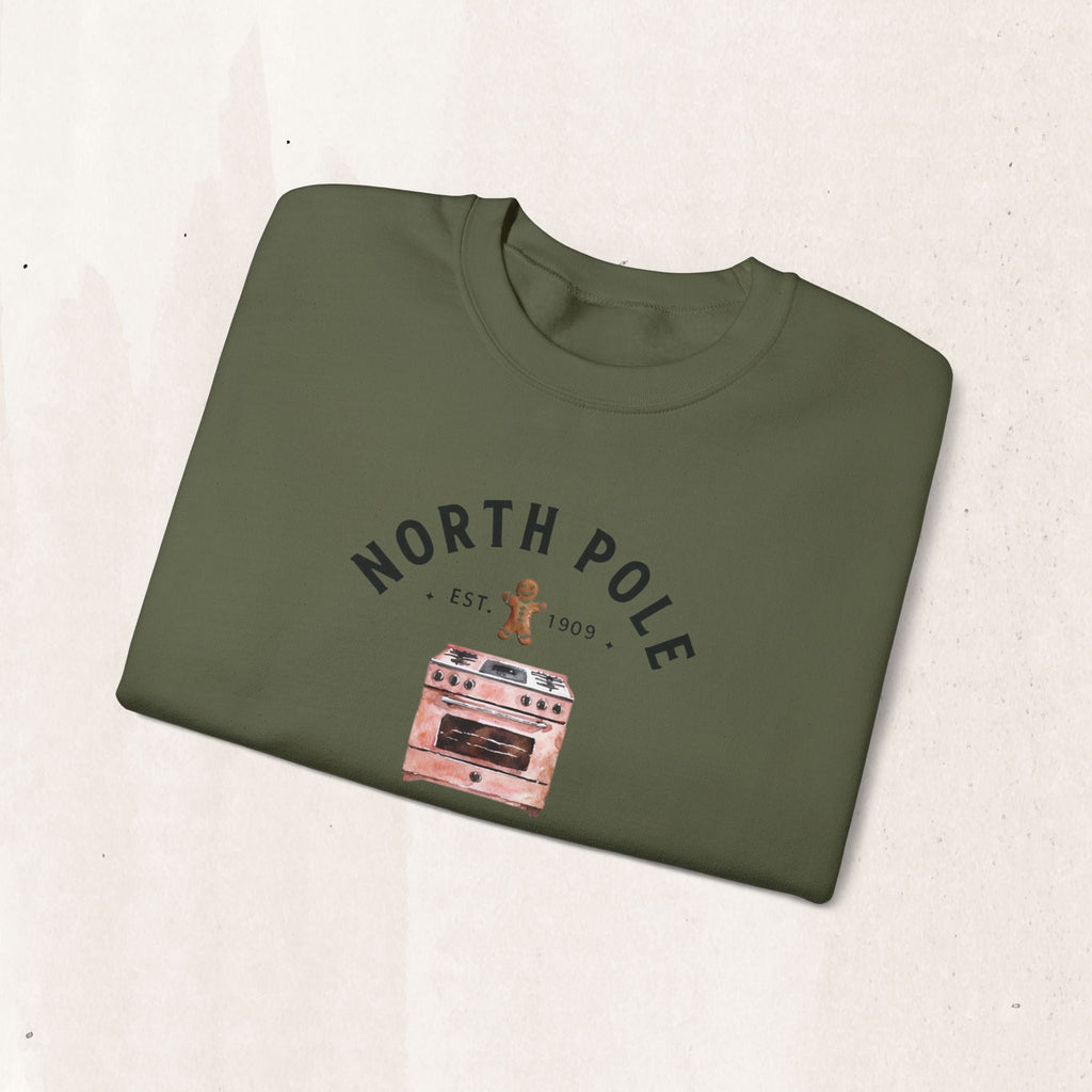 Wicked Thread Society olive green crewneck sweatshirt with a North Pole Bakery oven and gingerbread man graphic.