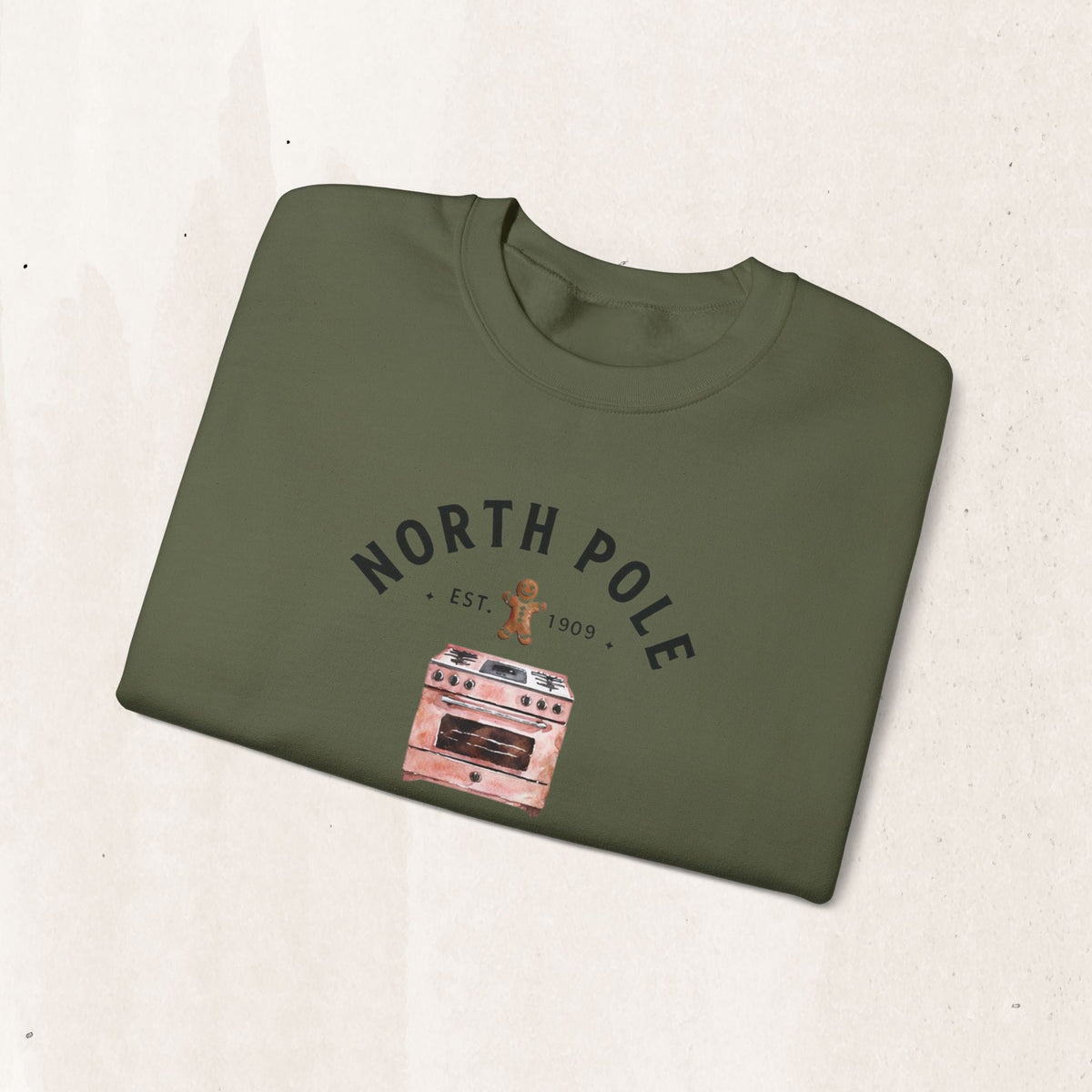Wicked Thread Society olive green crewneck sweatshirt with a North Pole Bakery oven and gingerbread man graphic.